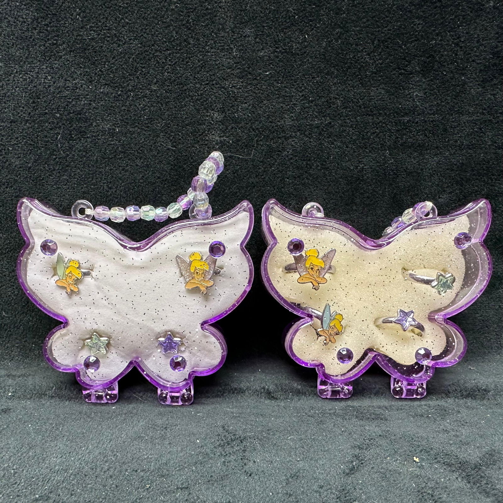 Disney Tinker Bell Purple Butterfly Case Costume Jewelry Set Fifteen 15 Sets: Disney purple butterfly jewelry case featuring four adjustable Tinker Bell Disney rings. Each jewelry case features four adjustable Disney rings. Fifteen case sets total. These items are in like-new,