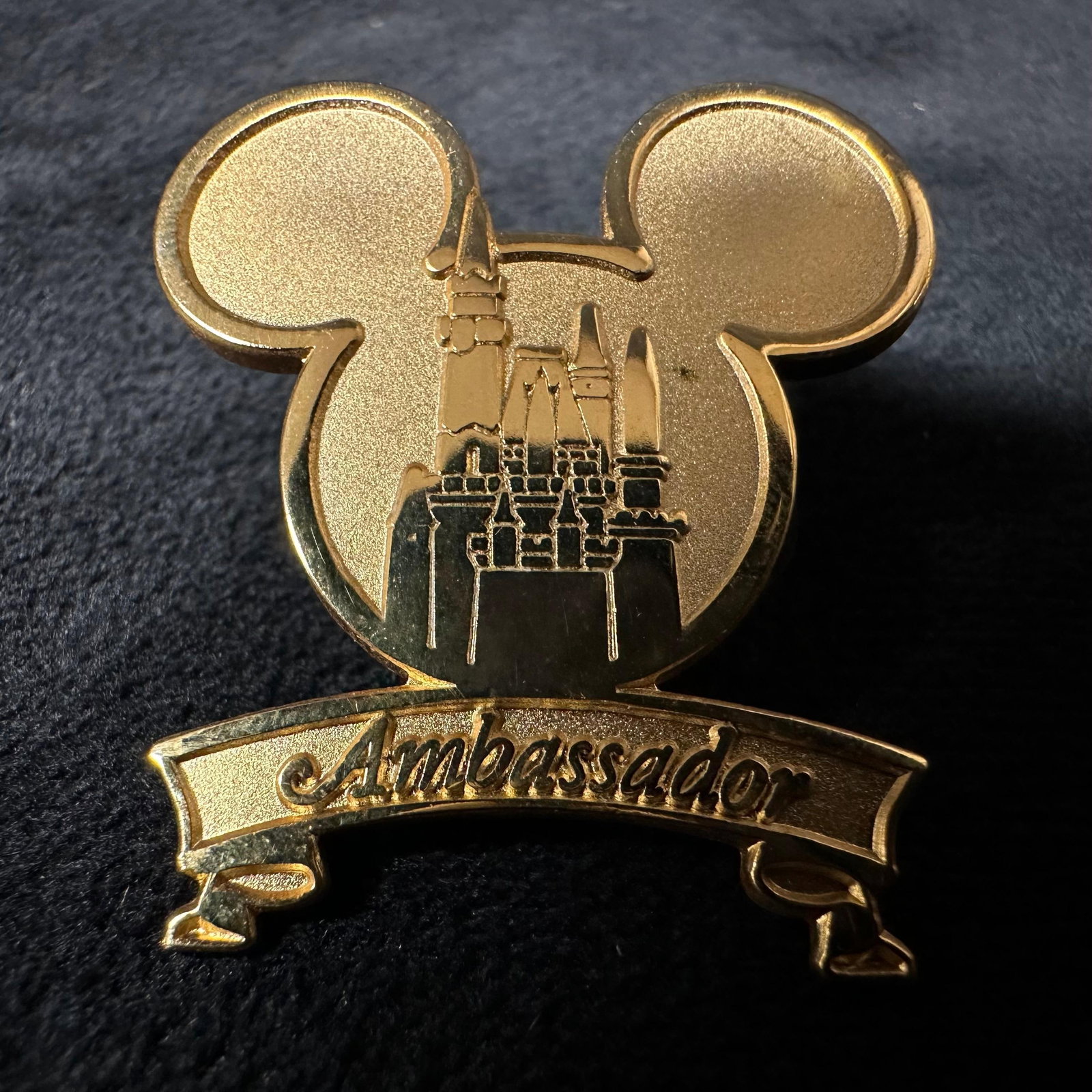 Ambassador Gold Tone Cast Member Disney Pin: Ambassador Mickey Head Icon Castle Cast Member Gold Tone Pin. This item is in good pre-owned, previously displayed condition with light wear and surface scratches. Please reference all photos for full