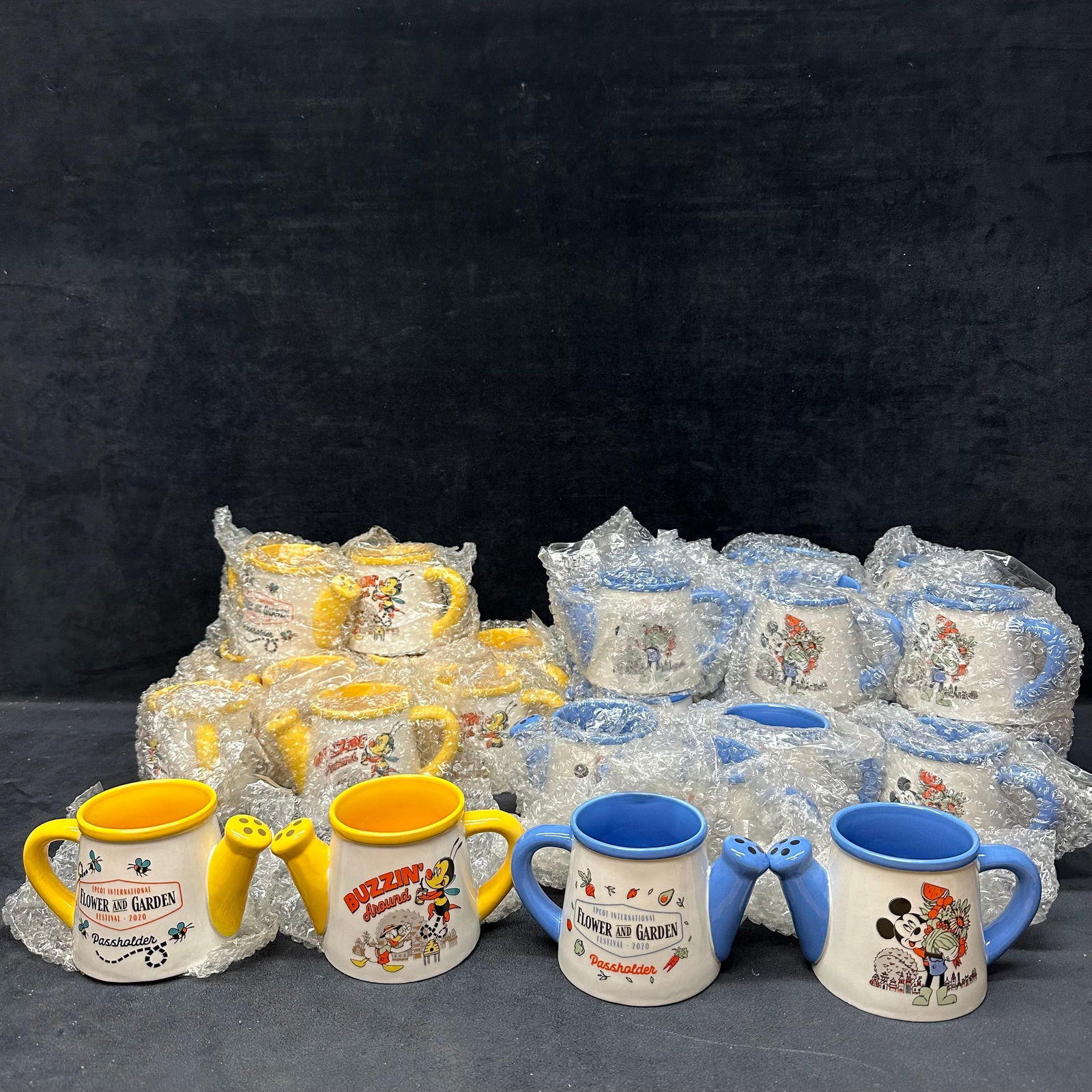 Disney Epcot Flower and Garden Festival Watering Can Mugs Mickey and Donald Duck Cup Lot of 29: A large lot of Twenty-nine 29 official Disney Parks ceramic watering can-style mugs from the EPCOT International Flower and Garden Festival 2020 Passholder Collection. Includes 18 blue Mickey Mouse mu