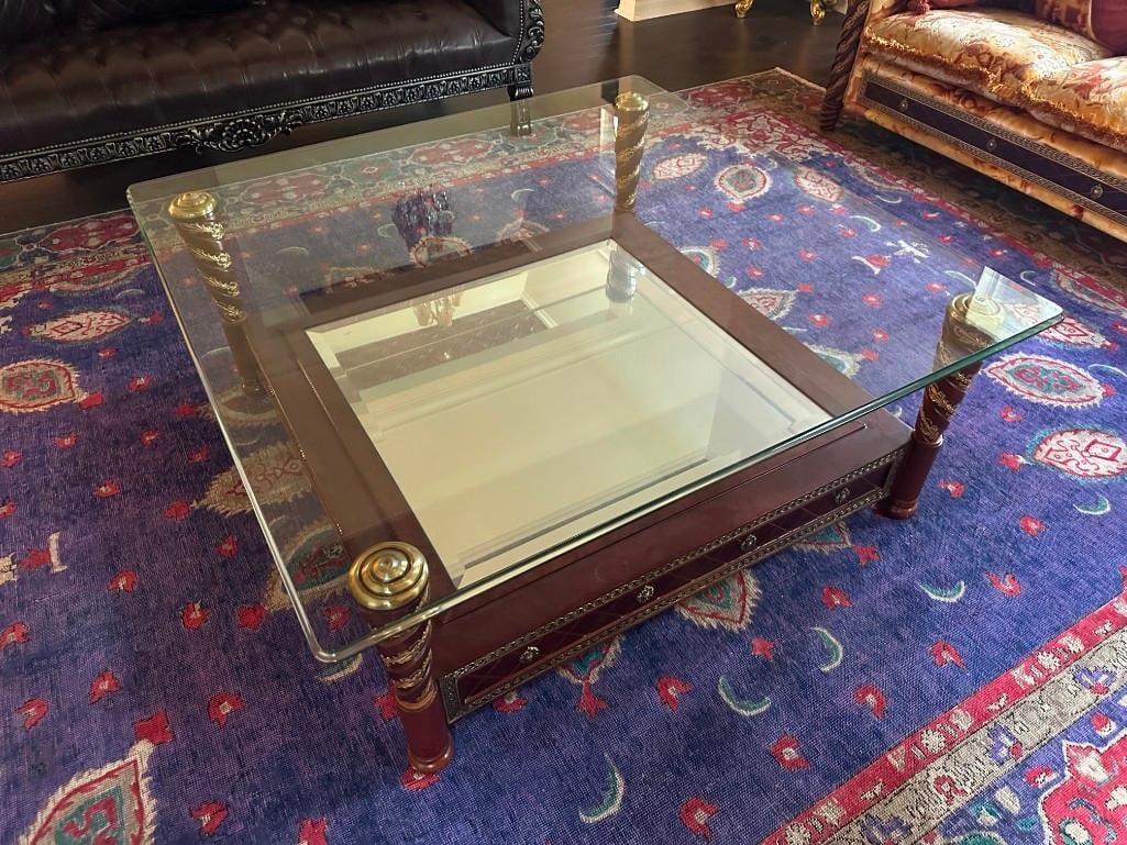 Large Custom Wood Coffee Table With Glass Top: Beautiful wood coffee tabel with hand-carved embellishments, with mirror in the center and glass top. Please see the photos for best description of condition. Measures: 47" x 47" x 20" I