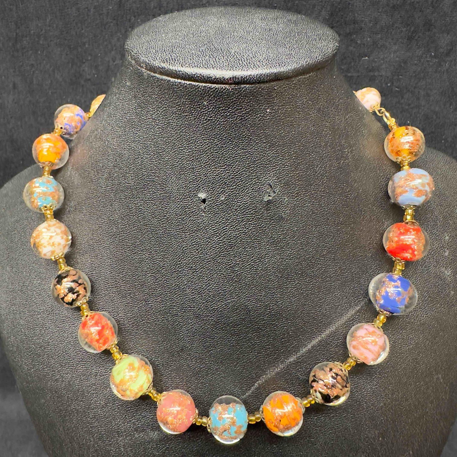 Venetian Murano Art Glass Lamp Work Multi Colored Beaded Copper Infused Accent Necklace C95: Venetian Murano Art Glass Lamp Work Multi Colored Beaded Copper Infused Accent Necklace C95. Necklace with multi colored glass beads with beautiful designs on each. The necklace features copper accent