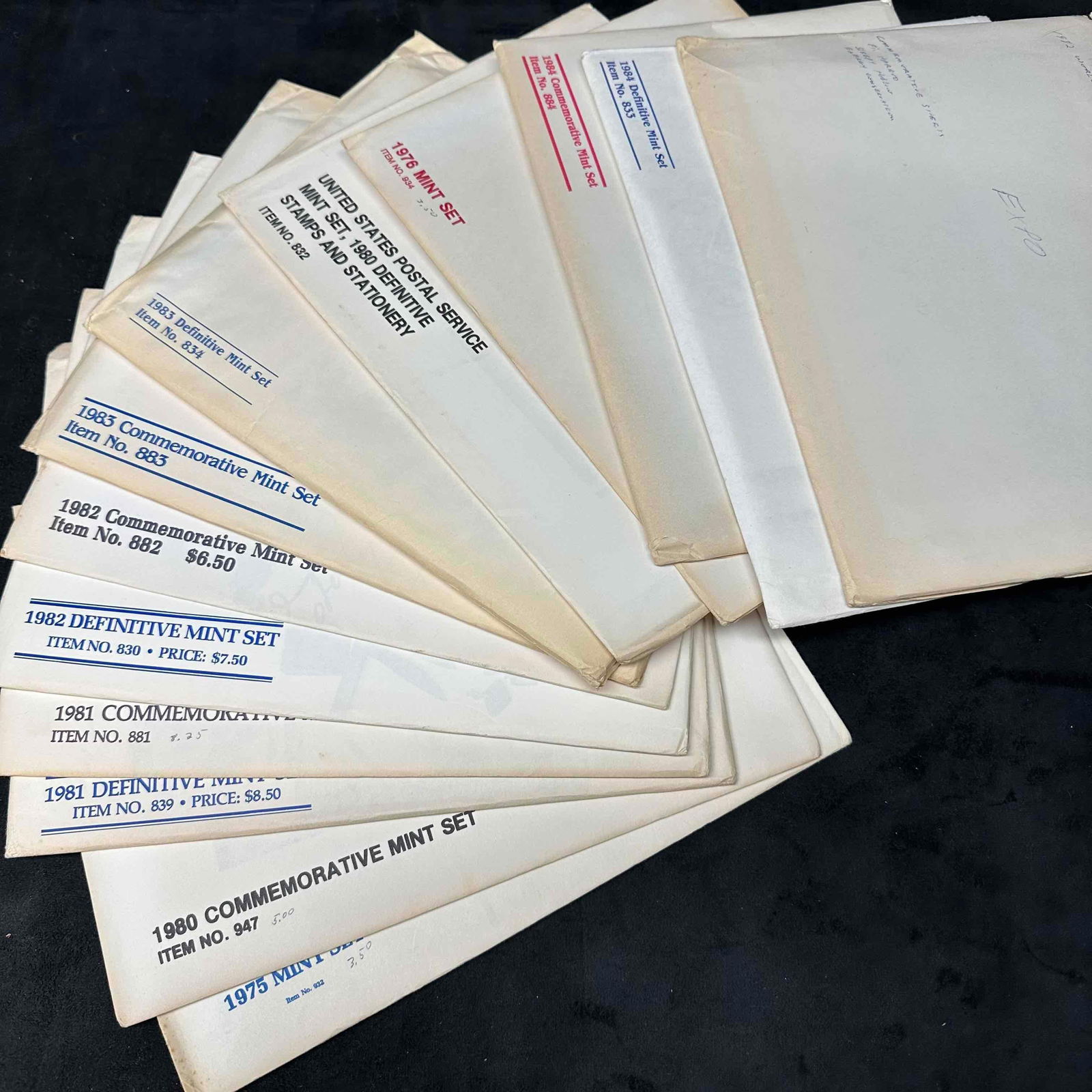 Mixed Lot US Commemorative Stamps Mint Set: Each set includes US Stamps, booklets, and other collector pieces. Thirteen sets included from the late 70's to 1980's. These items are in good pre-owned, previously displayed condition with l