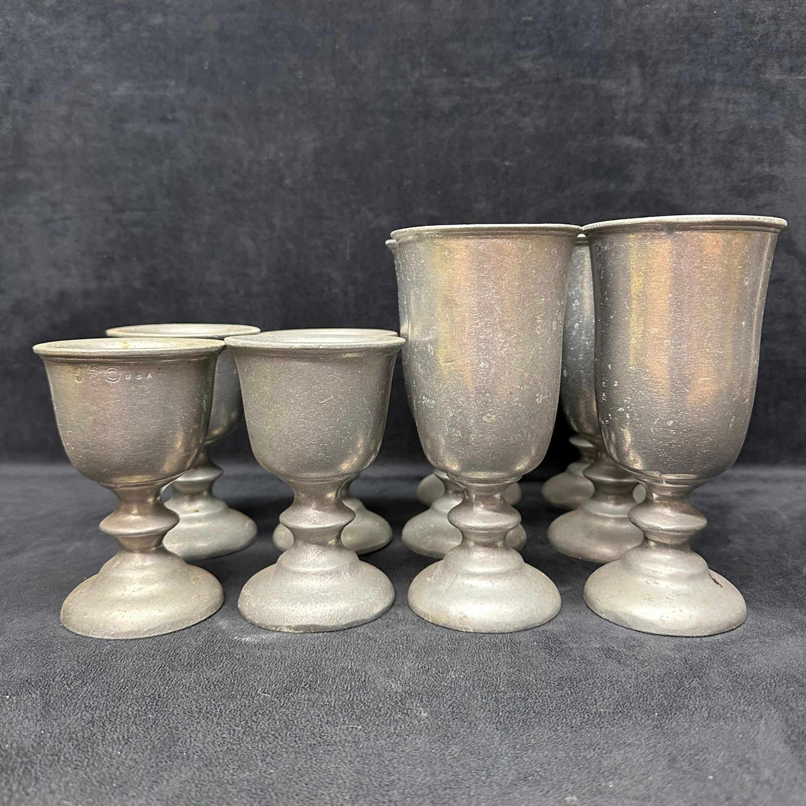 Set of Ten Wilton Armetale Pewter Goblets Tavern Colonial Style Drinking Cups: Set of ten vintage Wilton Armetale pewter goblets in two graduated sizes, each featuring a classic Colonial tavern design with round bases and flared rims. Produced in Columbia, Pennsylvania, these du