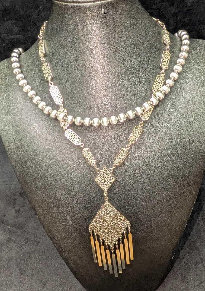 Vintage Crown Trifari Silver Tone Beads And Tasseled Necklaces: Vintage Crown Trifari Silver Tone Beads And Tasseled Necklaces. This lot includes: (1) Crown Trifari Silver Tone Beads Necklace. This is approx 24". (1) Unmarked Silver Tone Tasseled Abstract Fil