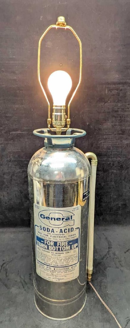 Converted General Fire Extinguisher Table Lamp: Converted General Fire Extinguisher Table Lamp. Here is an vintage General Fire Extinguisher that had been converted into a lamp. The lamp is approx 8" x 7" x 33" and it weighs 7lbs. Without the harp