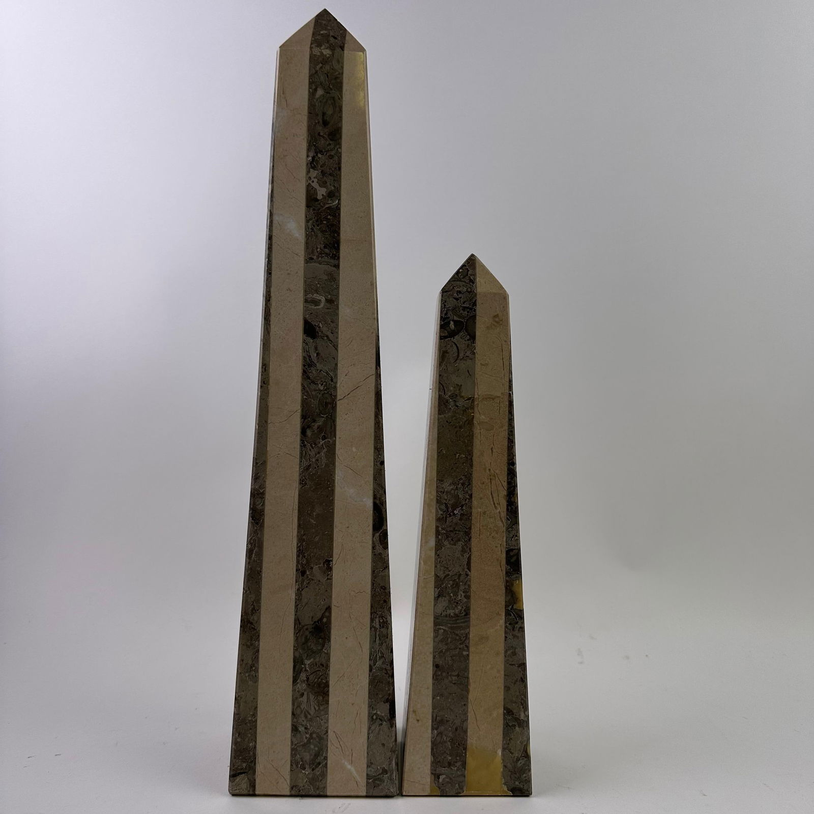 Mid-Century Modern Style Mixed Stone Marble Obelisk Form Architectural Paperweight Decor: Pair of polished mixed-stone marble obelisks in a strong architectural form, consistent with Mid-Century Modern and Art Deco revival design aesthetics. Each example is vertically faceted with clean ge