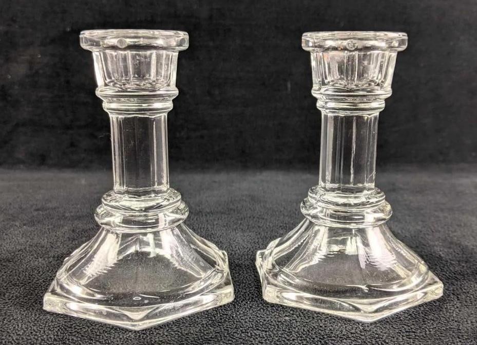 Glass Candlestick Holders: Glass Candlestick Holders. These are elegant clear glass candlestick holders. These take long candlesticks and are the perfect centerpieces. These are pressed glass in good condition. Each is approx 3