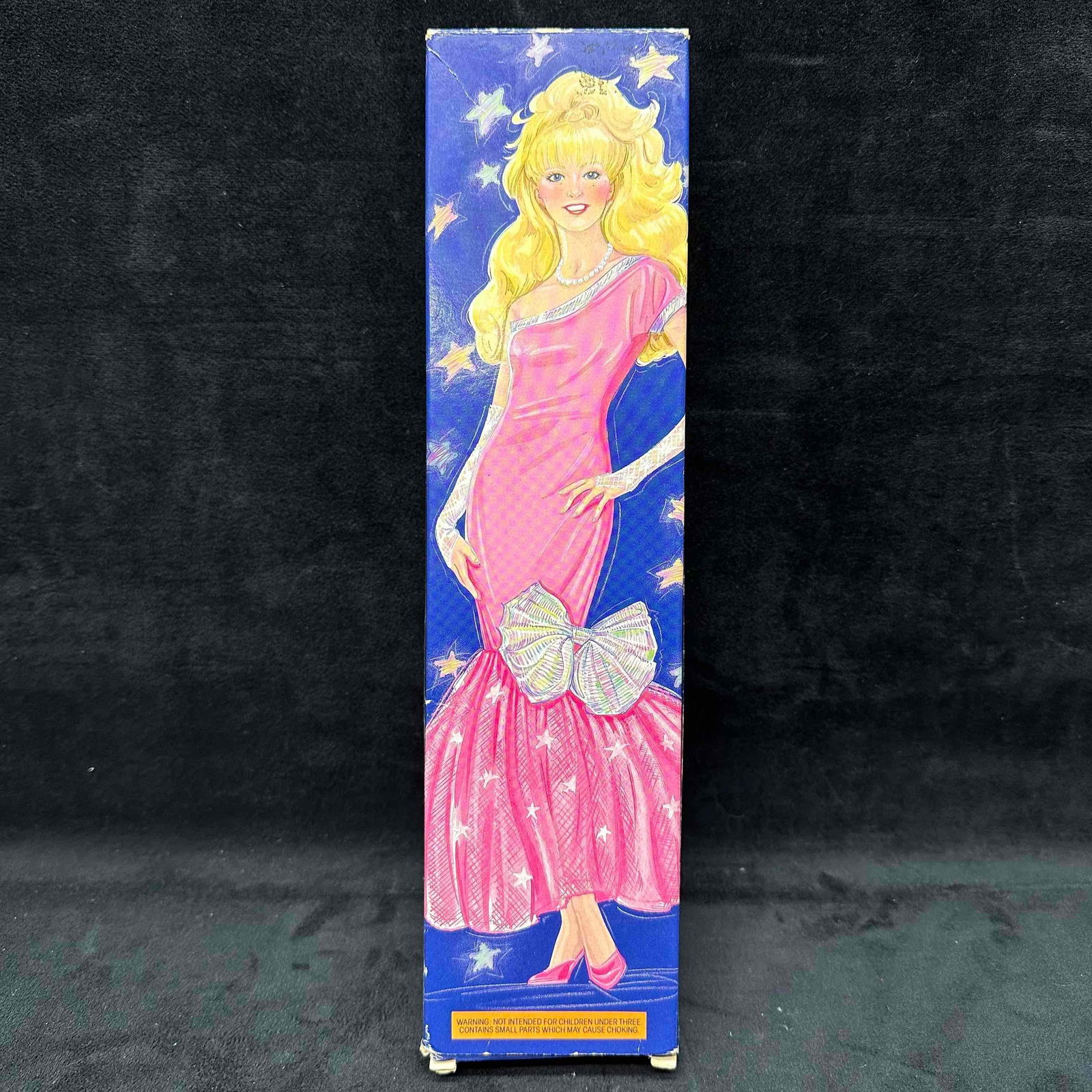 Avon Jenna Fashion Doll with Original Box: Avon Jenna fashion doll in original box. Doll is dressed in a pink gown with silver bow accent, pearl necklace, and matching accessories. Doll remains sealed in original plastic wrap. Box shows light