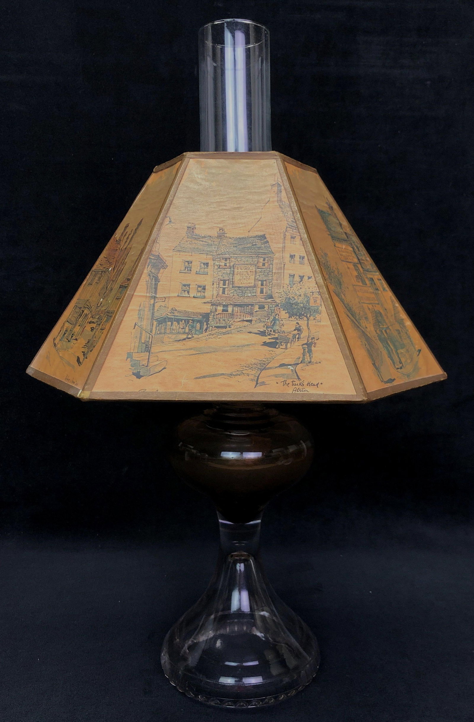 VTG Oil Lamp & Philip Bawcombe Watercolor Shade: Vintage Oil Lamp with Artist Philip Bawcombe Watercolor Shade. Shade features watercolors of old English Inns. The Vintage Lamp is approximately 19" x 12-1/2" x 12-1/2" and weighs about 2.5lbs. Overal