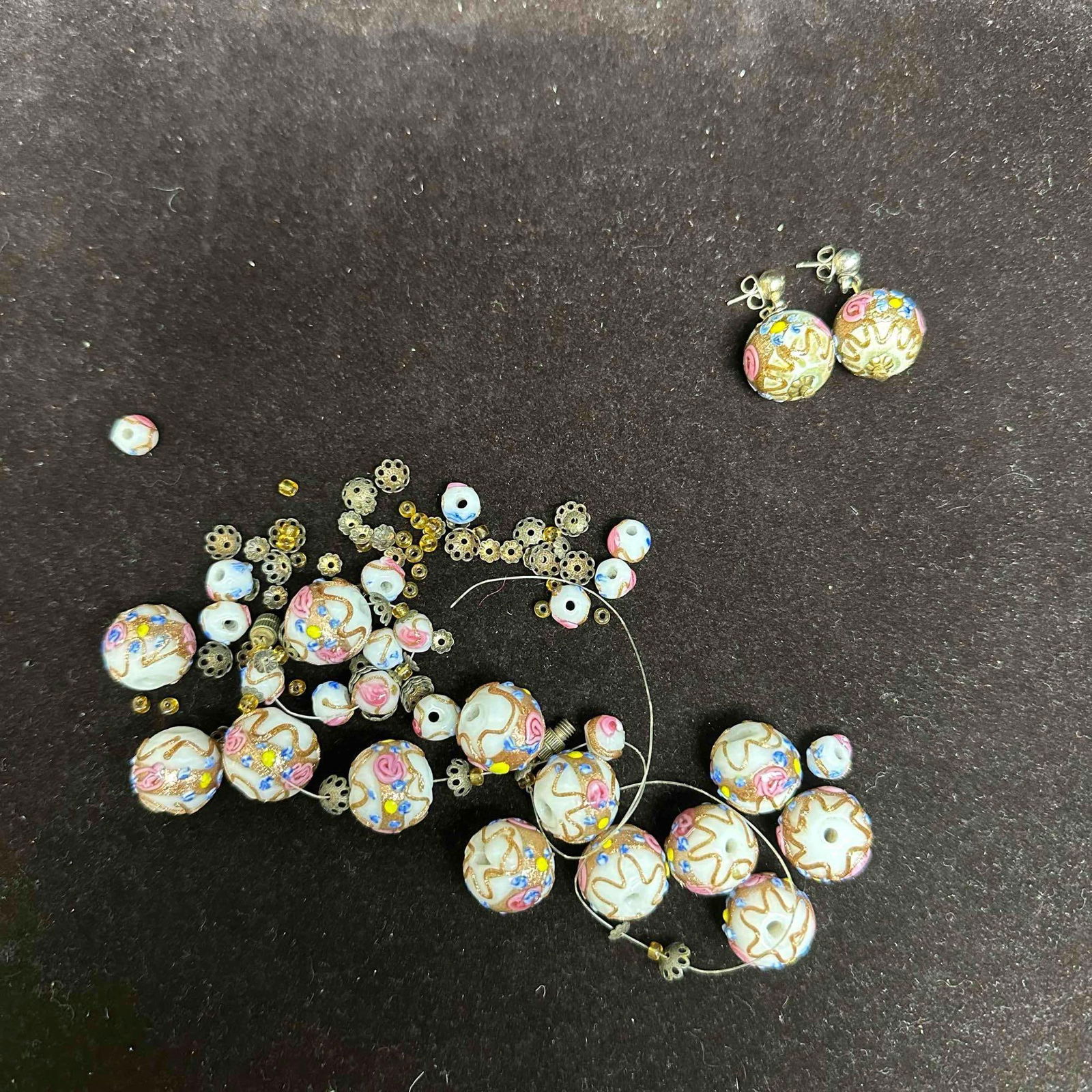 Murano Lamp Work Art Glass Fiorato White Bead Broken Necklace Pieces and Earrings Set: Necklace (broken, in need of repair) and earrings with white colored glass beads with beautiful hand painted designs on each. The necklace and earrings feature floral and copper colored accents. The n