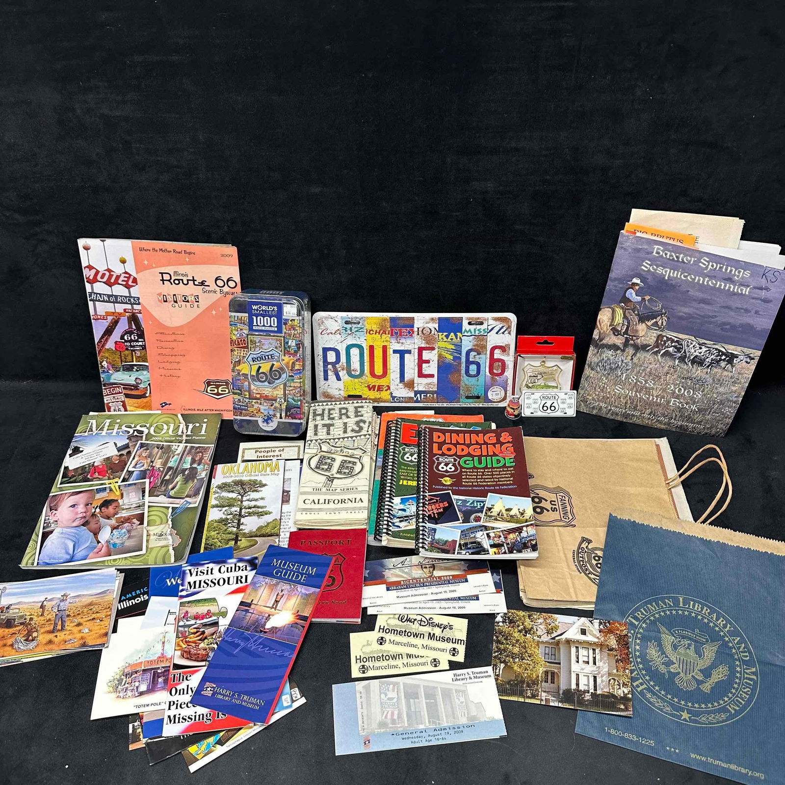 Large Lot of Route 66 Road Trip Memorabilia Maps Books and Souvenirs: Extensive collection of Route 66 and road trip memorabilia, including travel guides, maps, postcards, brochures, and souvenir items. Highlights include a Route 66 license plate sign, dining & lodg