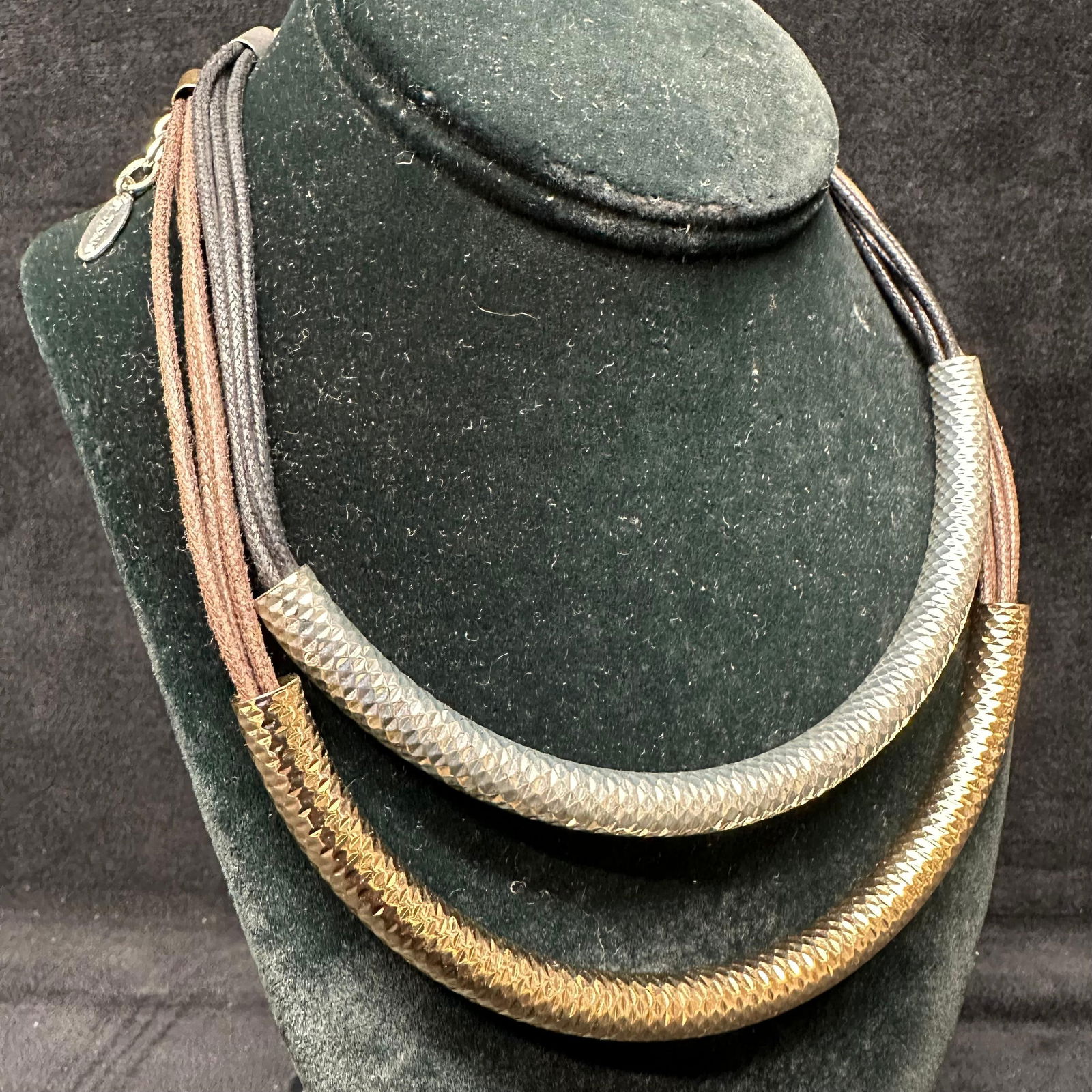 St. Thomas Multi-Strand Mixed Textured Metal Fashion Necklaces Set: Pair of St. Thomas brand fashion necklaces, each featuring multiple fabric strands with textured curved metal tube accents. One necklace has bronze-tone strands with a gold-tone tube, and the other ha