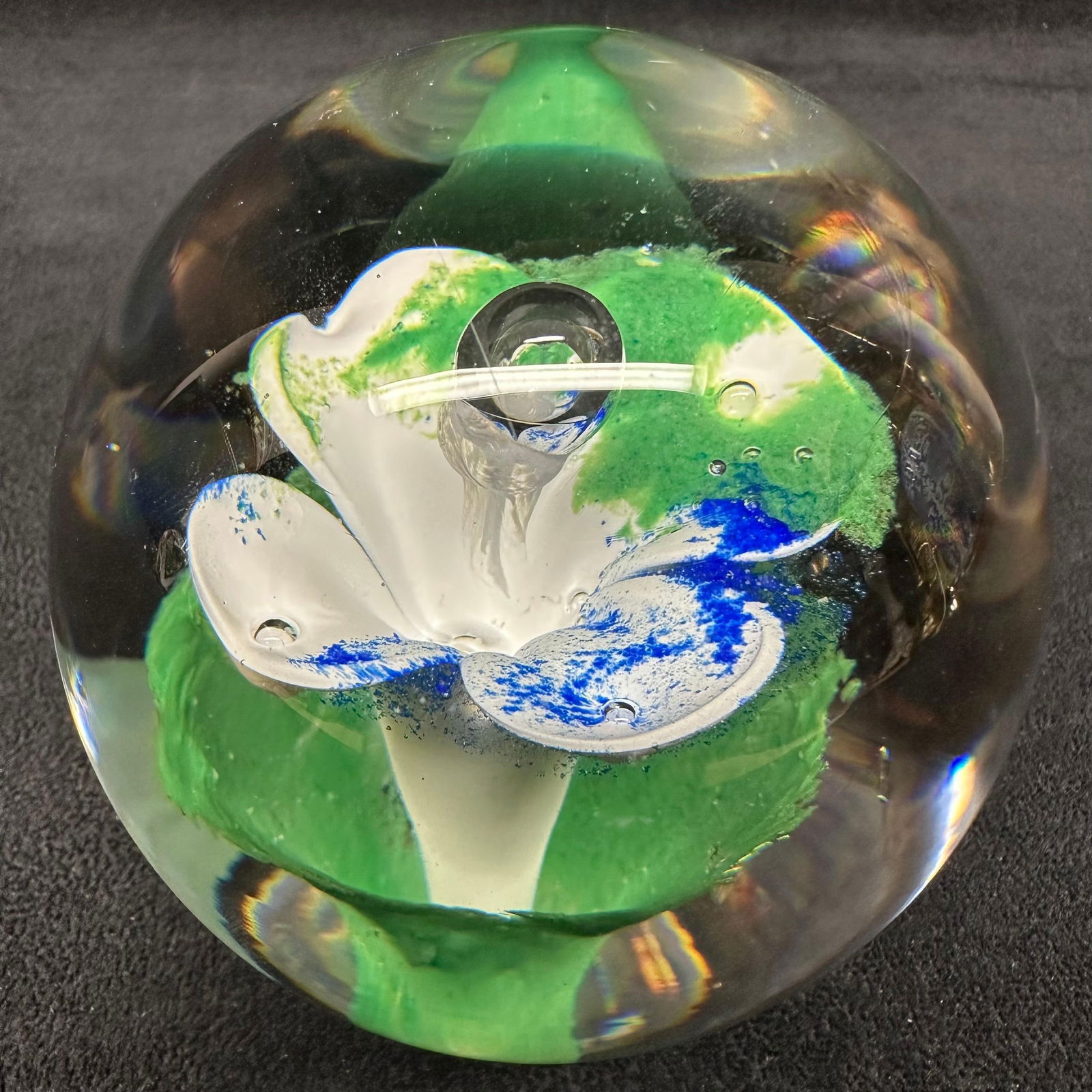 Studio Ahus Sweden Art Glass Paperweight Floral Abstract Blue Green White Flower: Studio Ahus art glass paperweight featuring a clear spherical form with an internal abstract composition in green, white, and blue glass. Designed and produced in Sweden. Retains original Studio Ahus