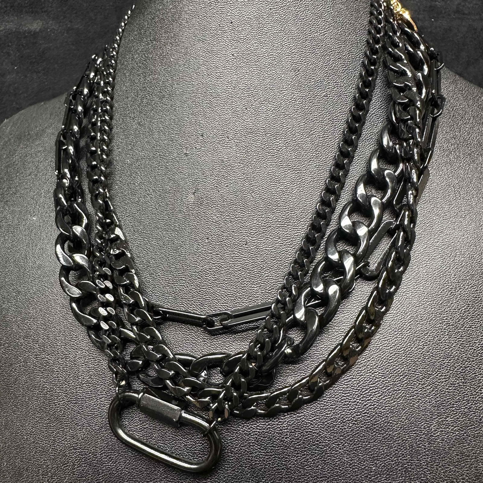 Melania Clara Jet Black Chain Assorted Necklace Set Modern Design: The Melania Clara necklace set features a magnet clasp closures. The necklaces have magnet extender clasp closures. Each necklace showcase modernist designs with a jet black toned chain design. These