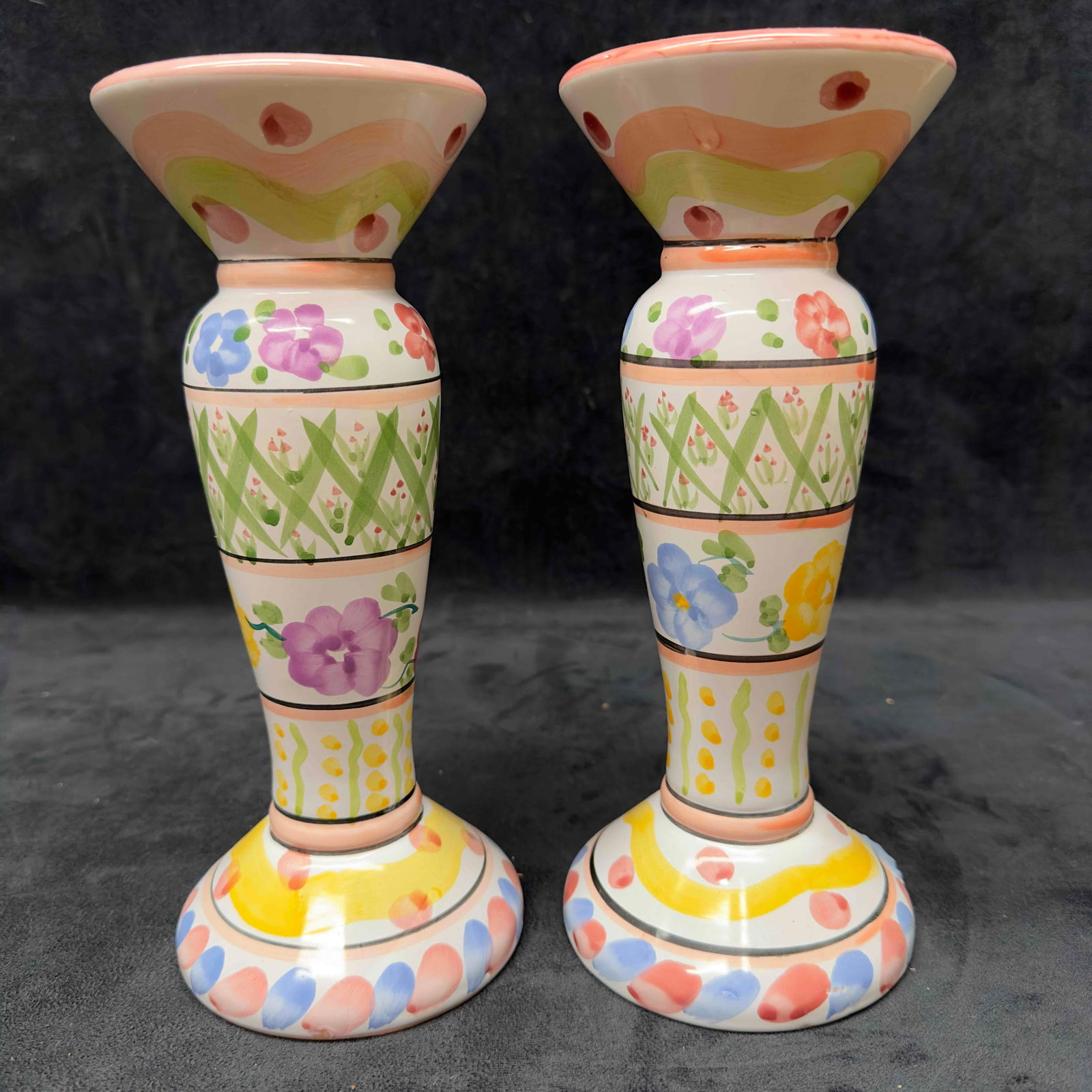 World Bazaar Whimsical Candlestick Holder Set Multicolor Floral Pillar Candle Holders: World Bazaar Whimsical Candlestick Holder Set Multicolor Floral Pillar Candle Holders. This candle holder set features a whimsical floral design throughout with multiple colors. One pillar has been re
