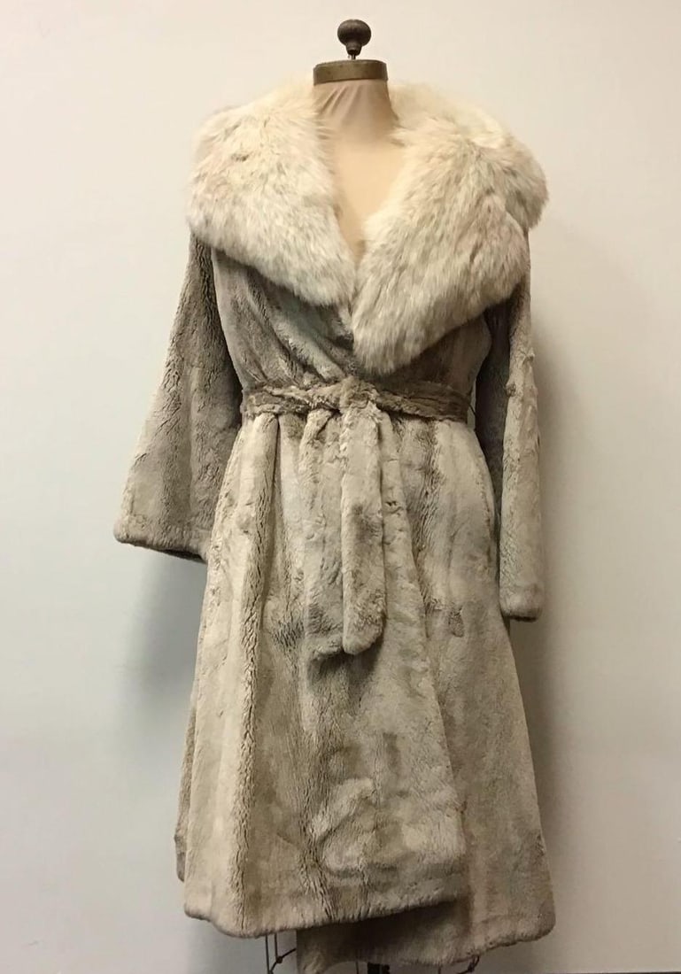 Beige Beaver Coat with Fox by Bifanos: Beige Beaver Coat with Fox by Bifanos. This coat features a sash, brown interior linen, the name "Joan R. Benham" embroidered on the right interior panel, two exterior pockets and a "Designed by Bifan