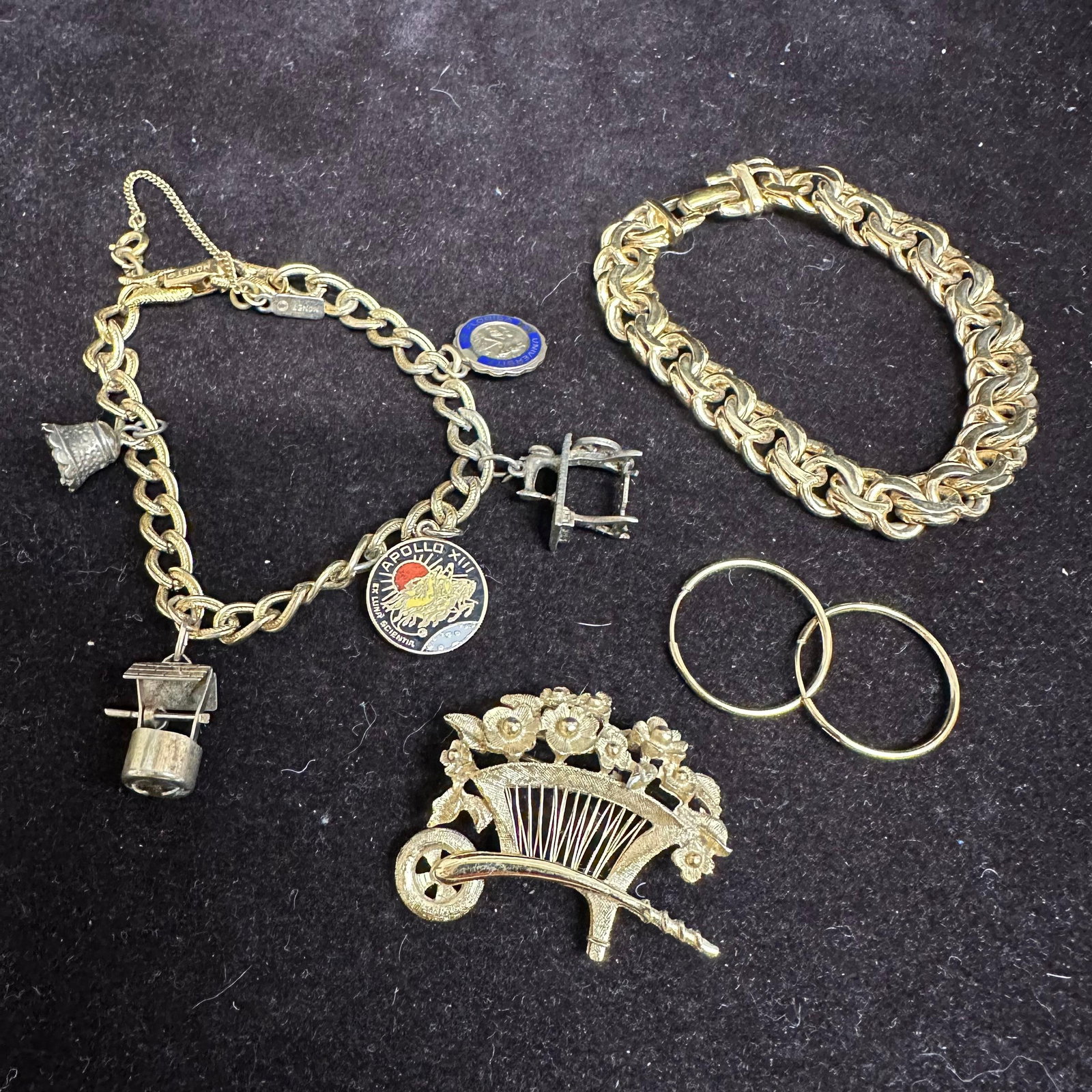 Monet Signed Jewelry Lot Charm and Chain Link Bracelet Brooch and Earrings: Collection of vintage Monet signed gold-tone jewelry, including a charm bracelet with Apollo 14, University of Florida, and movable charms, a chunky chain link bracelet, a floral basket brooch, and a