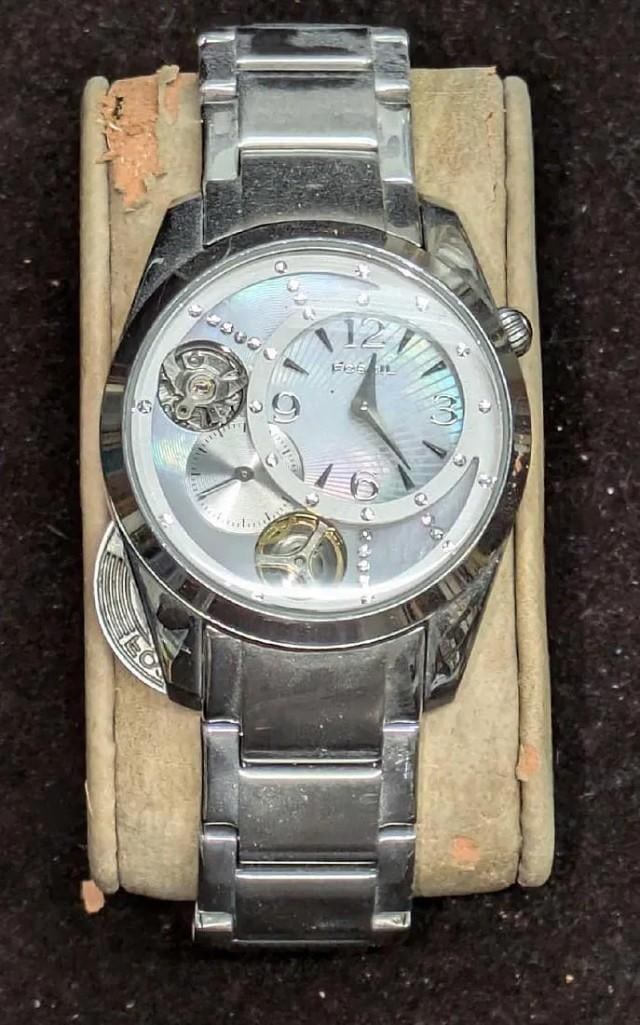 Women's Fossil Twist Semi-Automatic Watch: Women's Fossil Twist Semi-Automatic Watch. Untested. This is approx 1 1/4" x 3/4" x 3 3/4" and it weighs 0.29lb. The "Twist" backing came off. Stainless steel with water resistant in 5ATM