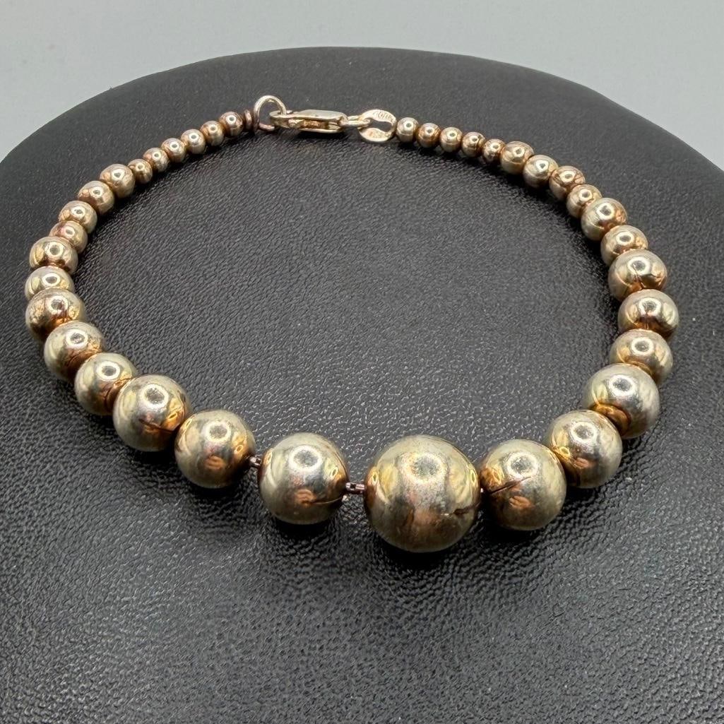 Sterling Silver Graduated Bead Bracelet: This piece of jewelry has been tested and researched prior to listing. Please view all our pictures they are part of our description. DETAILS: Metal - Sterling Silver Color - Silver Stones - none Hall
