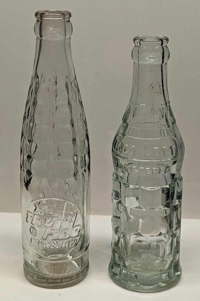 Vintage Coco-Leti And Tru Ade Glass Bottles: Vintage Coco-Leti And Tru Ade Glass Bottles. This lot includes: (1) Vintage Coco-Leti 6 oz glass bottle. This is approx 2 1/2" x 2 1/2" x 7 3/4". The bottle has some markings and scratche