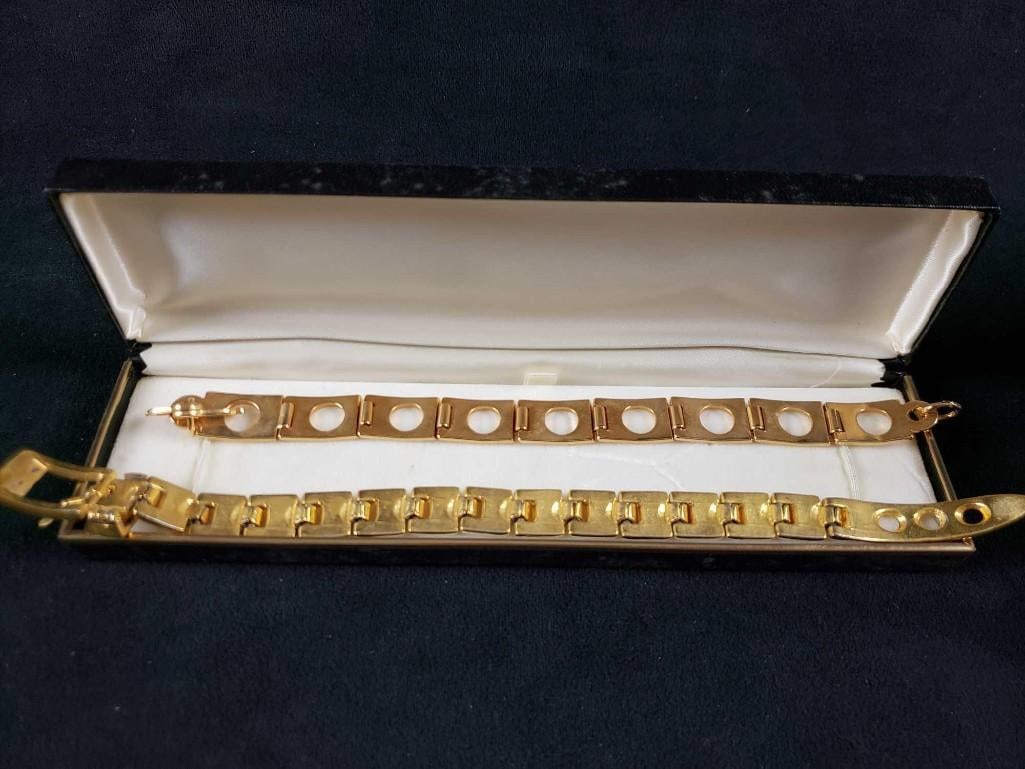2 Gold Colored Bracelets: 2 Gold Colored Bracelets. These bracelets are in good used condition. The gold covering the surface has worn away in areas leaving a silver color underneath. The two bracelets included in this lot are