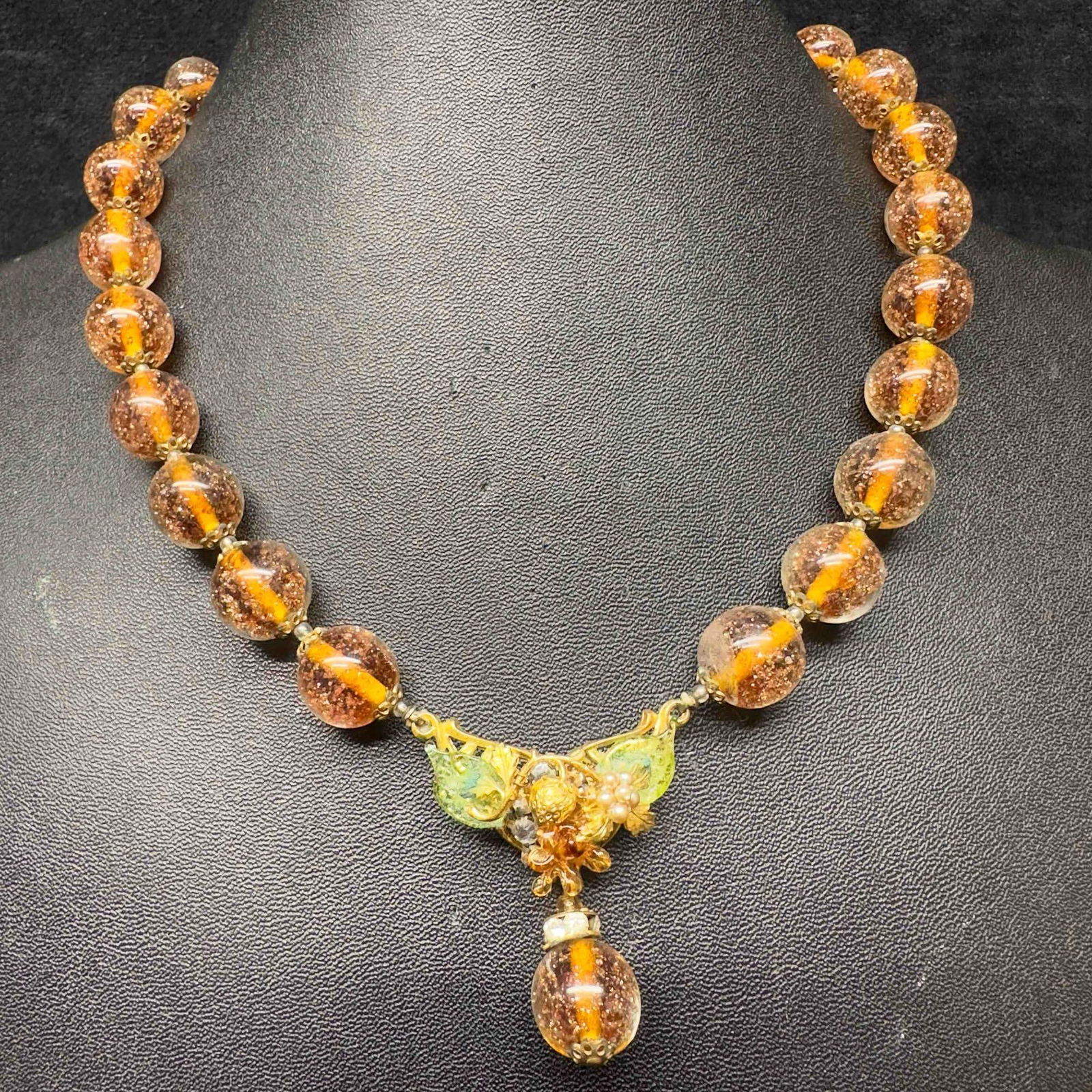 Murano Venetian Lamp Work Art Glass Copper Orange Beaded Flower Pendant Necklace C82: Murano Venetian Lamp Work Art Glass Copper Orange Beaded Flower Pendant Necklace C82. Necklace with orange colored glass beads with beautiful designs on each. The necklace features copper colored acce