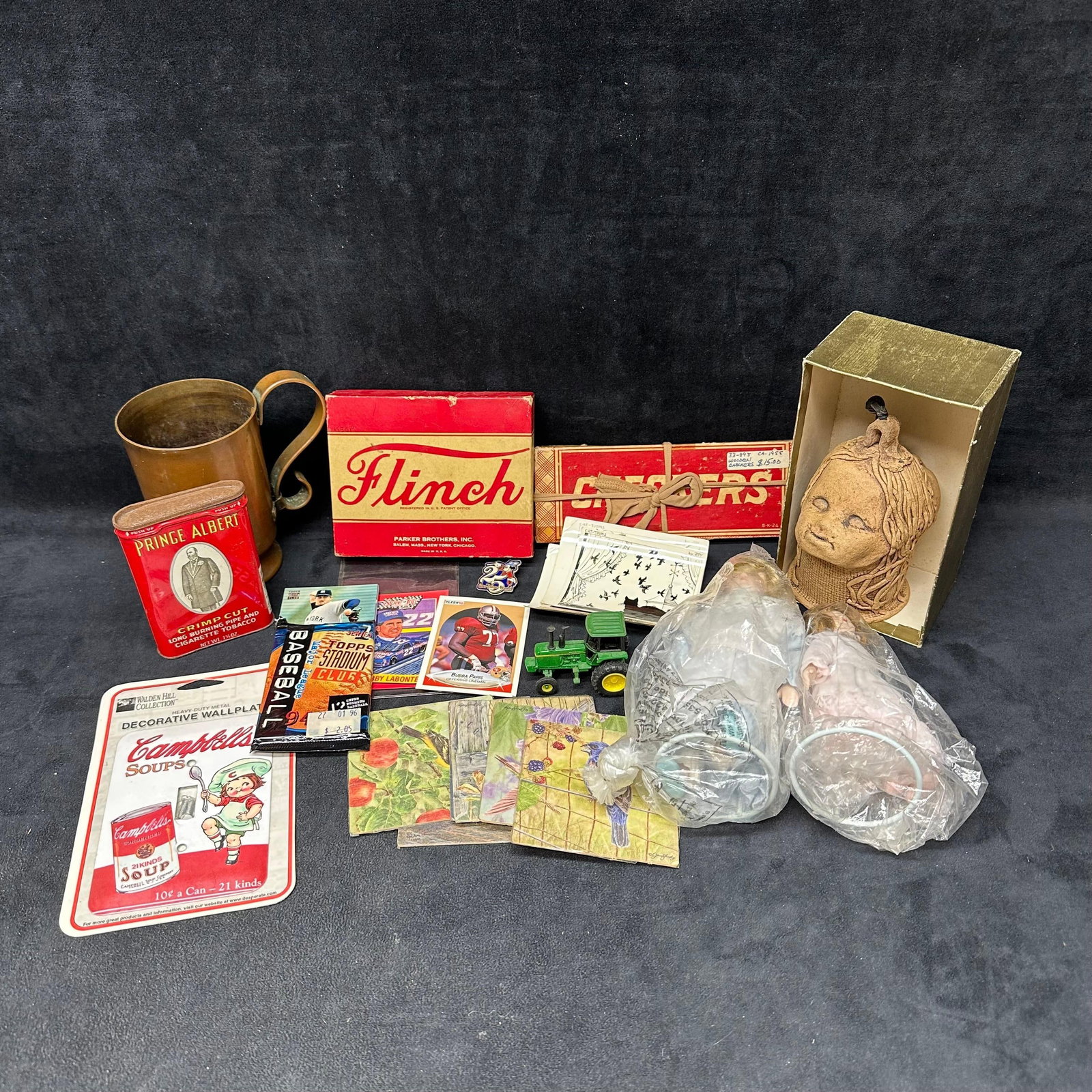 Mixed Vintage and Collectible Assortment Lot Games Tins Cards Dolls and Decor: Assorted mixed lot of vintage and collectible items. Includes a variety of pieces such as vintage games, advertising tins, trading cards, small toys, dolls, decorative coasters, prints, a Disney pin,