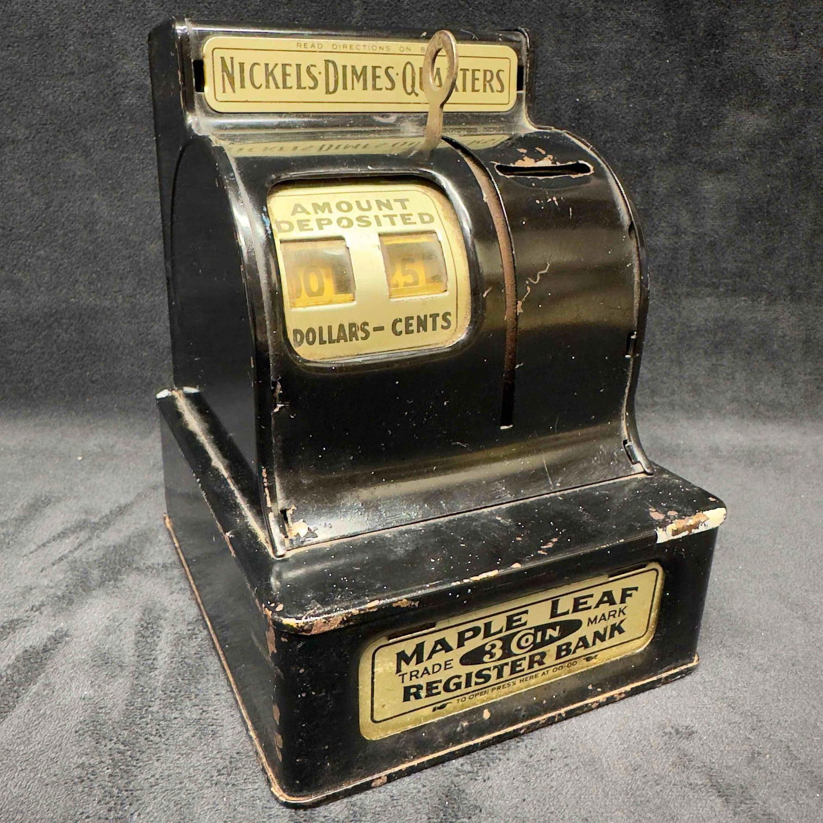 Maple Leaf Register Bank By The Durable Toy & Novelty Co. Black Three Coin: Maple Leaf Register Bank By The Durable Toy & Novelty Co. Black Three Coin. This is an antique, Uncle Sam's Register Bank. The bank registers nickels, dimes, and quarters. When the amount save