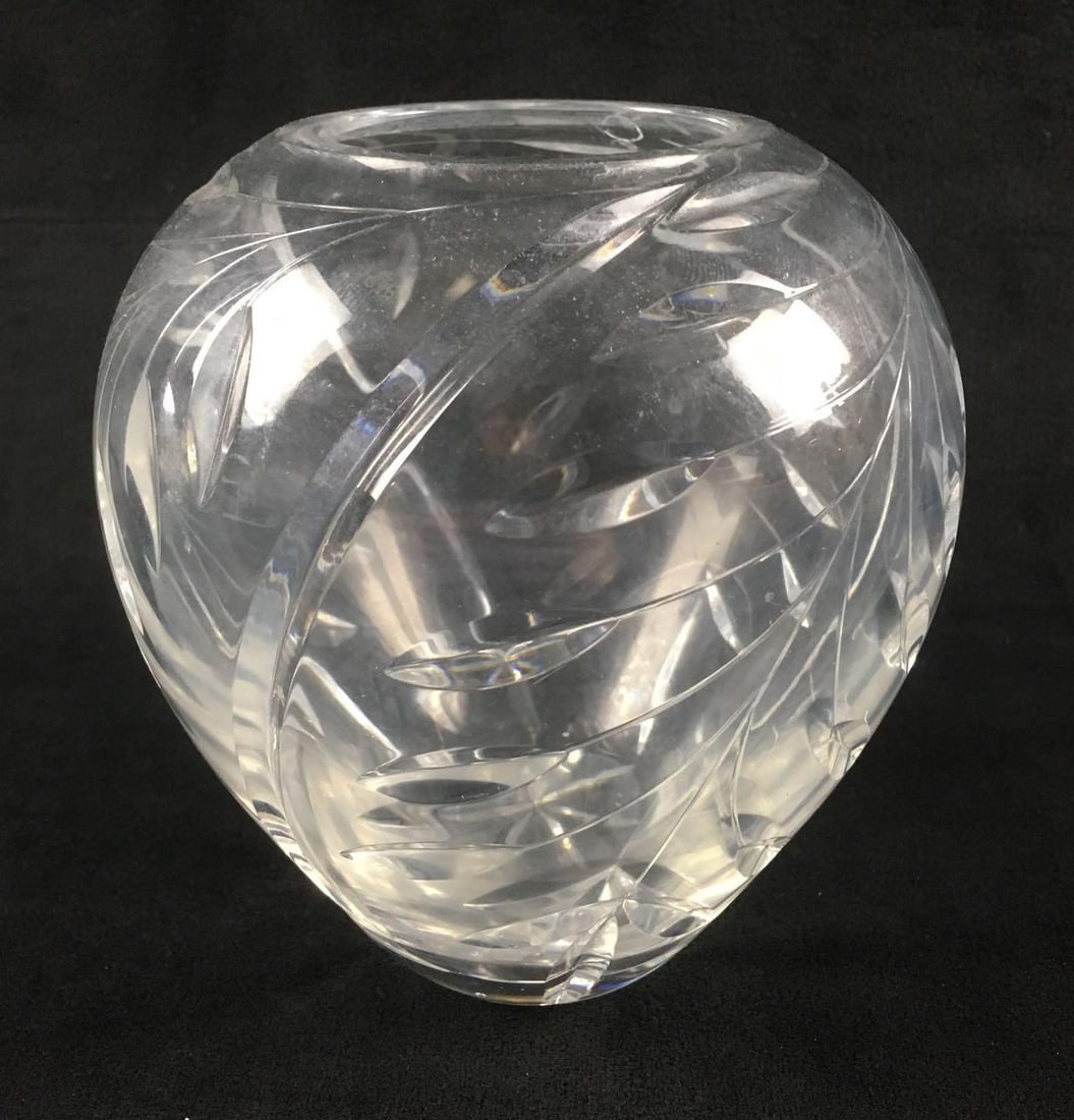 Cut Crystal Leaf Design Vase: Cut Crystal Leaf Design Vase. This vase is in good condition. It has some small scratches in the glass. The vase has a cut leaf pattern around the exterior. The vase measures 6" in height and about