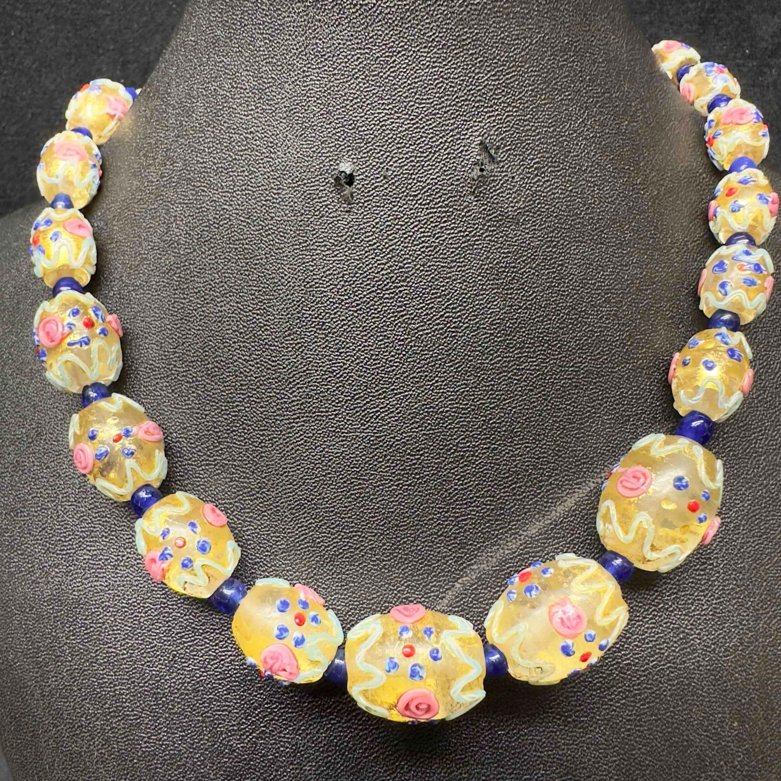Venetian Murano Art Glass Lamp Work Fiorato Creme Multi Colored Beaded Necklace D95: Venetian Murano Art Glass Lamp Work Fiorato Creme Multi Colored Beaded Necklace D95. Necklace with creme colored glass beads with beautiful hand painted designs on each. The necklace features copper c