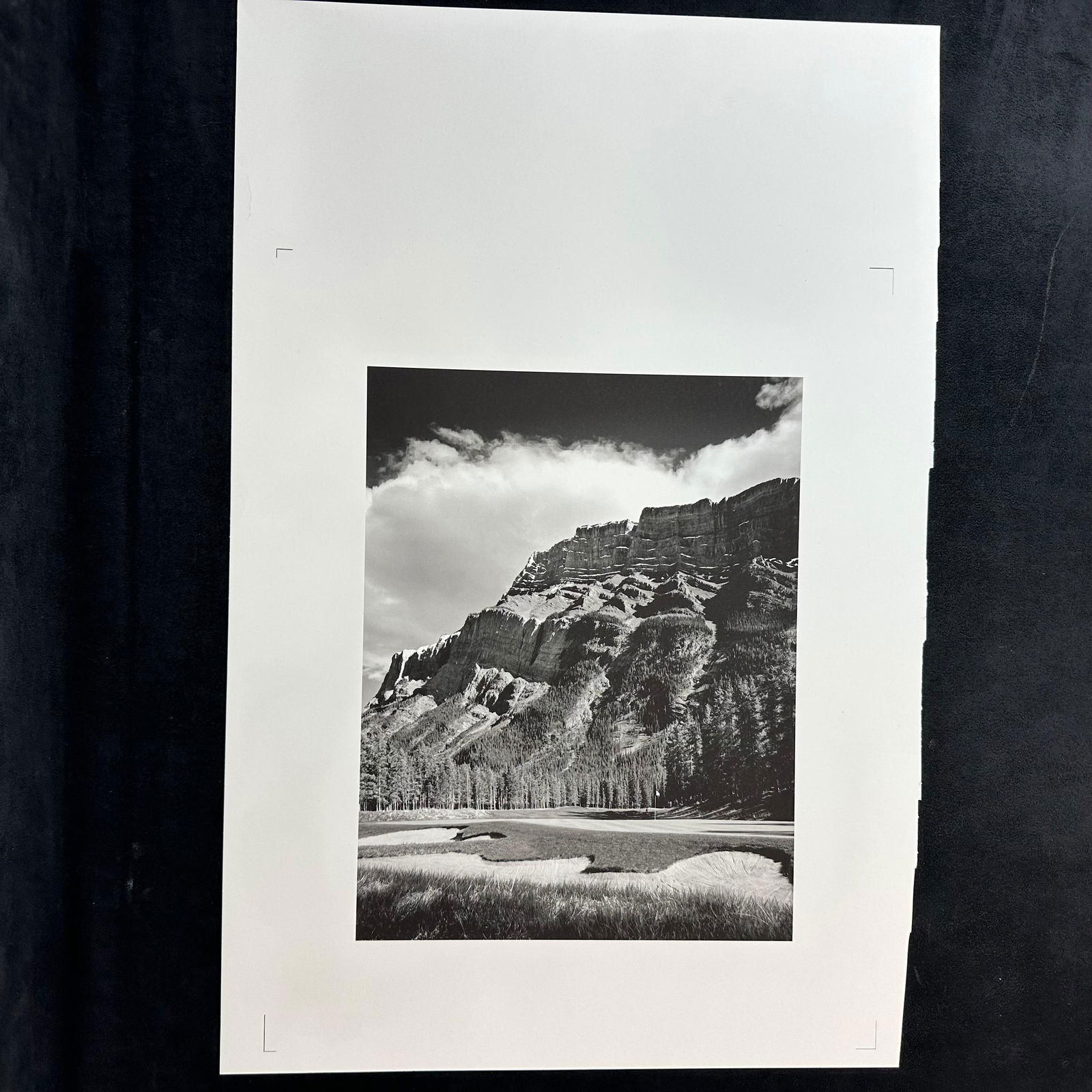 Black and White Fine Art Landscape Photo Print Mountain Scene with Cloudscape Overlook Golf Course: Black and white fine art photograph print depicting a dramatic mountain range under a textured sky with scattered clouds. The image captures layered rock formations and a sweeping valley foreground, o