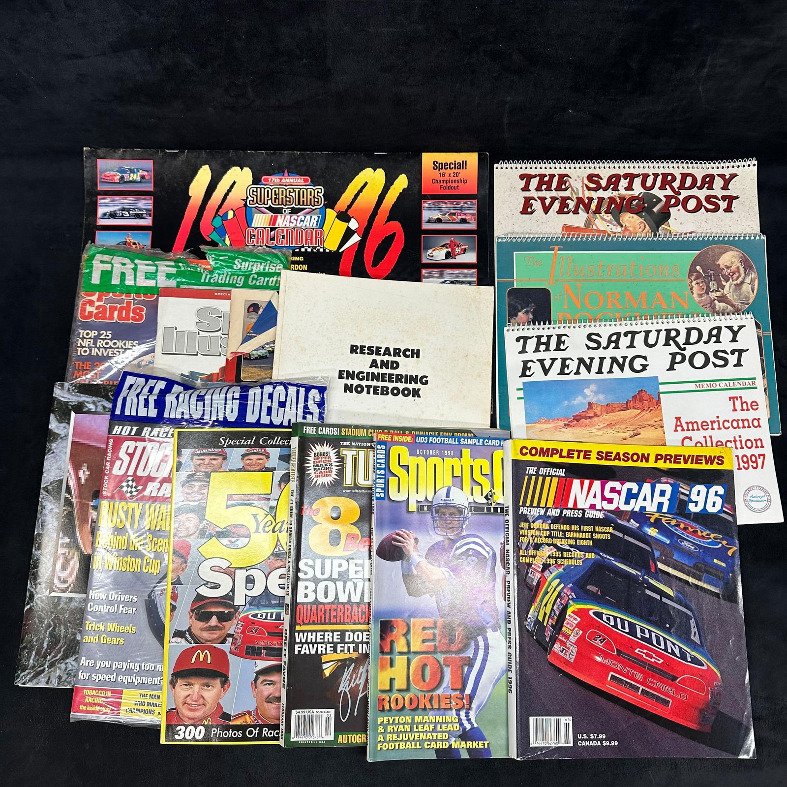 Sports NFL NASCAR Magazine and Vintage Calendar Set: A various variety of sports magazines and vintage calendars. Some of the magazines are sealed in plastic. These items are in pre-owned, previously displayed condition with light wear and surface scrat