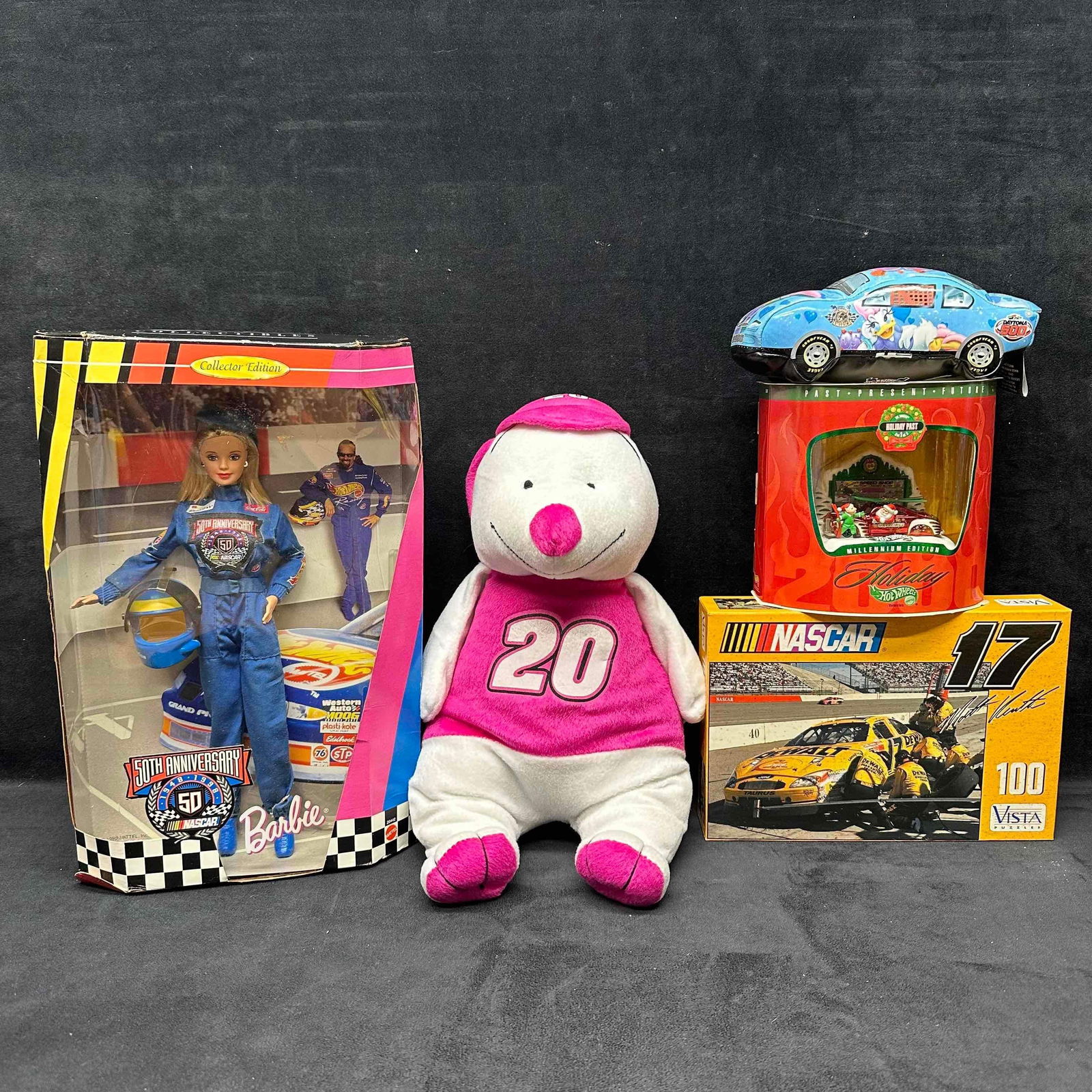 NASCAR Barbie Disney Hot Wheels Toy Collection of Five Collectibles: NASCAR Barbie Disney Hot Wheels Toy Collection of Five Collectibles. This NASCAR collection includes a Barbie Doll, a Disney Race Car Plush, Hot Wheel Holiday themedd car, a puzzle, and a pink and whi