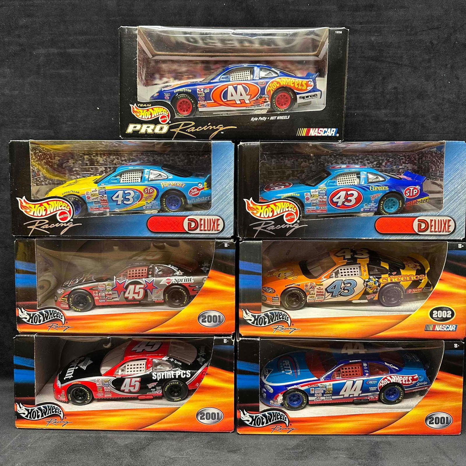 Hot Wheels Mattel Racing 1:24 Scale Die Cast NASCAR Race Stock Cars Collection Seven: Hot Wheels Mattel Racing 1:24 Scale Die Cast NASCAR Race Stock Cars Collection Seven. Each collectible is sealed new featuring seven NASCAR collectibles from the 1990's and 2000's. Outside pac