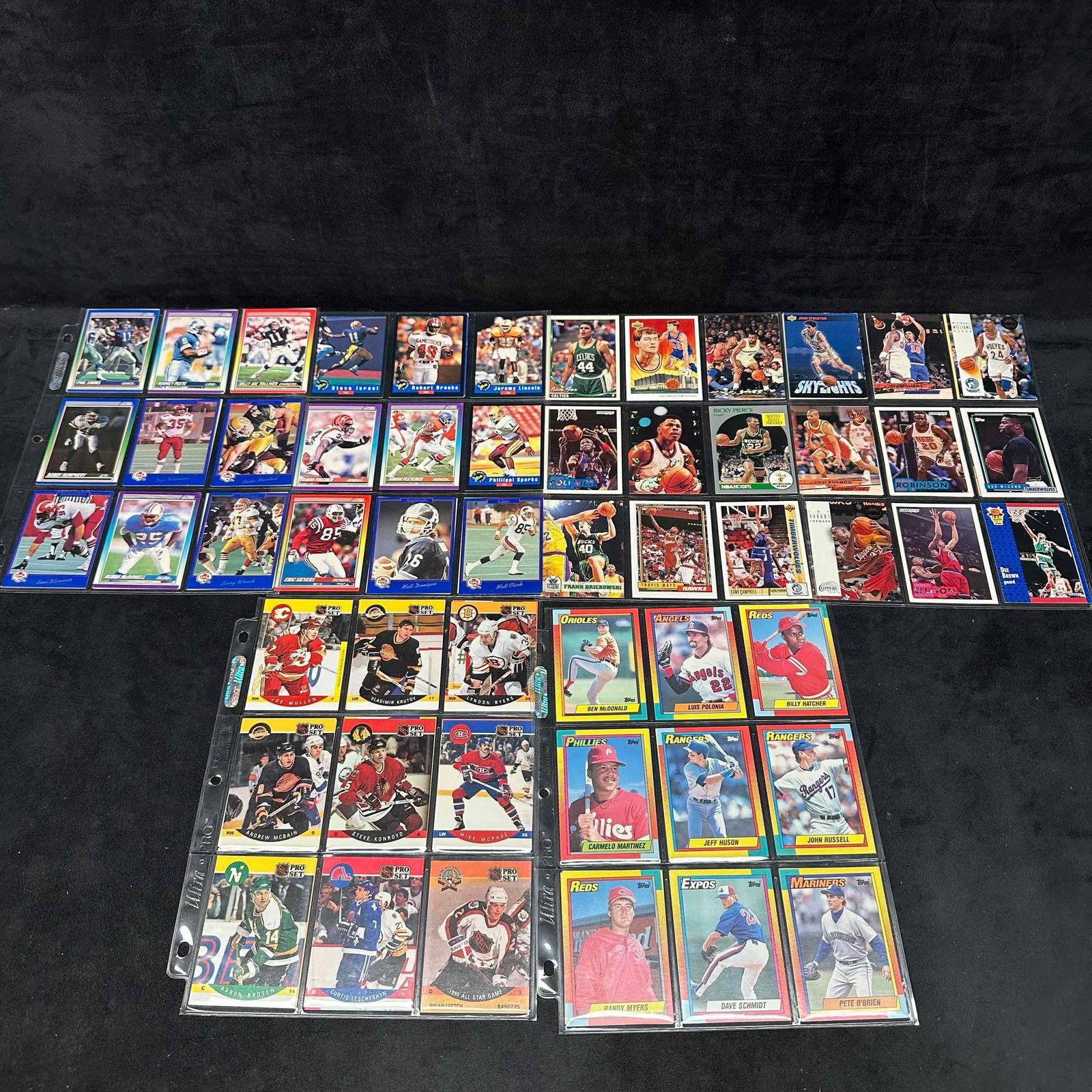 Collection of Sport Cards NFL Football MLB Baseball NHL Hockey NBA Basketball Card Binder: Ninety (90) plus cards included in this collection from various sports, all older sport cards. Includes Ultra-Pro card protector sleeves and green plastic binder. Dennis Rodman, Phil Simms, Cris Carte