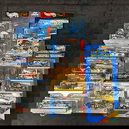 Lot of Fifteen Hot Wheels NASCAR Racing Die-Cast Race Cars: Collection of 15 Hot Wheels Racing die-cast cars, all sealed in original packaging. Includes NASCAR Pit Crew Series, Deluxe Editions, and Team Racers Gift Pack. Models feature #22 Caterpillar Daytona