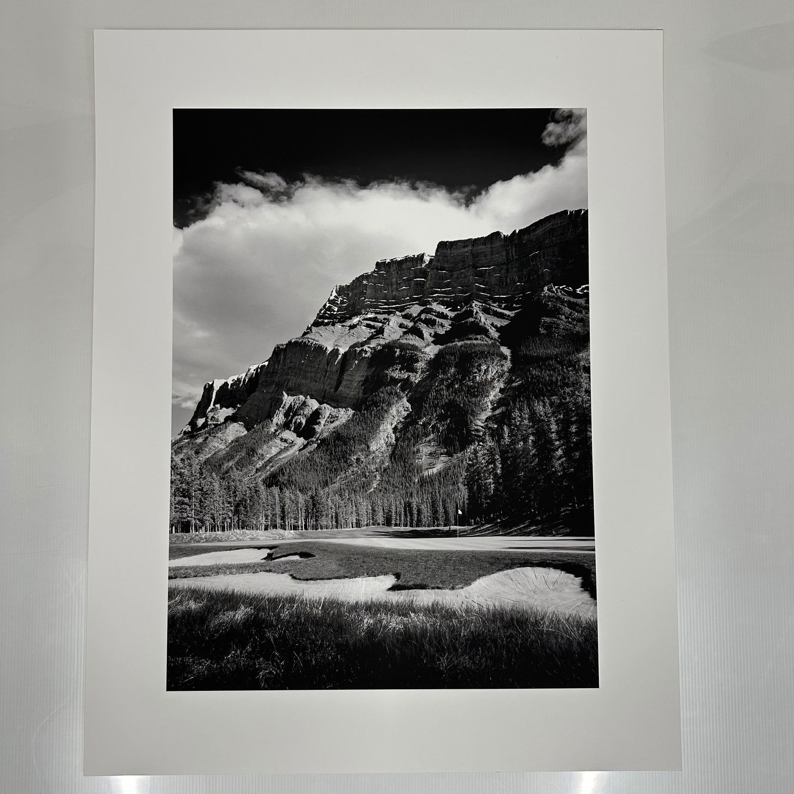 Black and White Landscape Photograph Print Mountain and Golf Course Scene Large Format B: Large format black and white photography print showing a dramatic mountain range rising above a golf course. The image features strong contrast, detailed texture, and balanced composition. Printed on