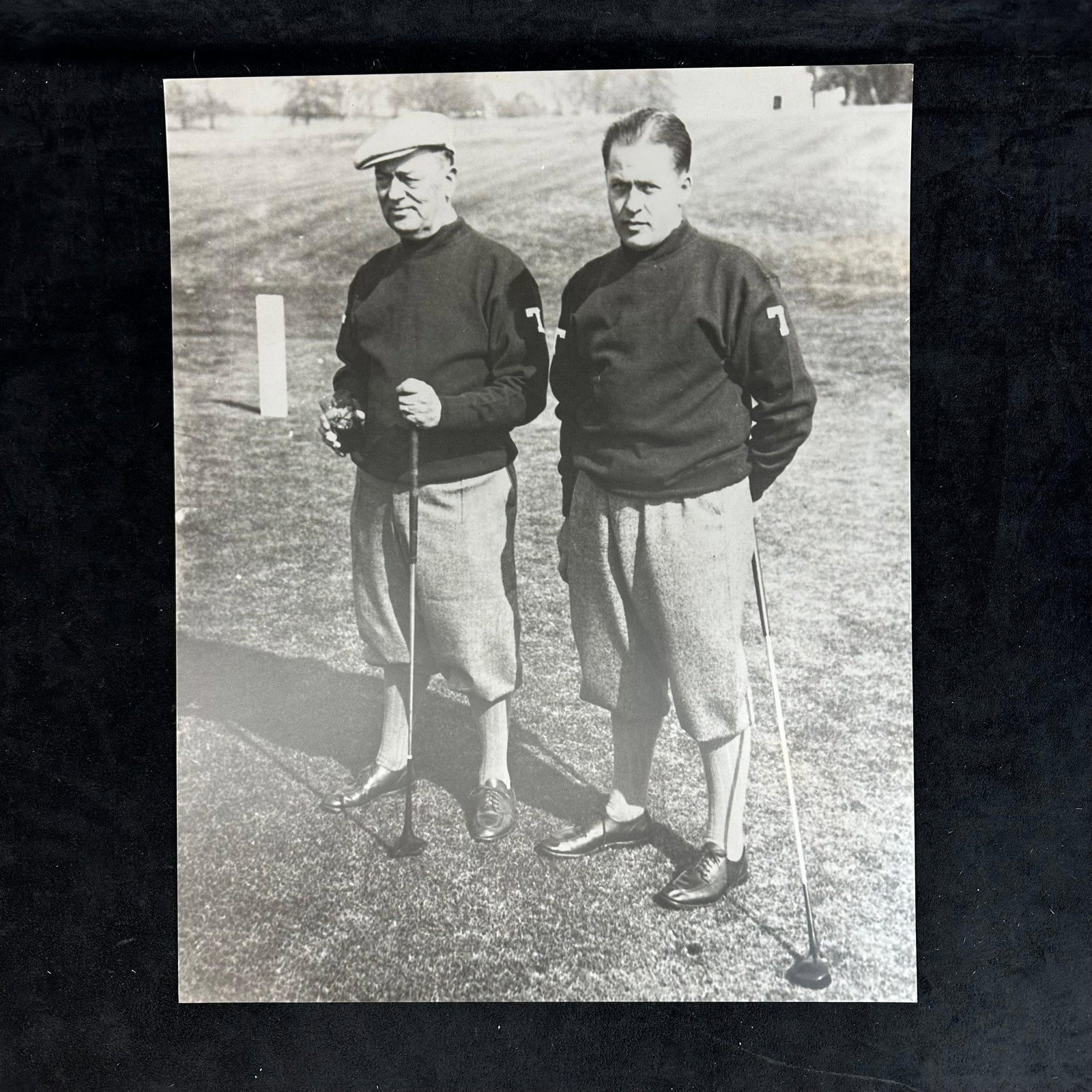 Black and White Golf Photography Print Bobby Jones and Colonel Robert P. Jones Vintage Golfers: Vintage style black and white photograph print capturing legendary golfer Bobby Jones alongside his father, Colonel Robert P. Jones, on the course. The image showcases both men dressed in traditional