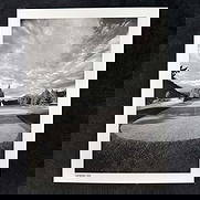 Canadian Sky Black and White Golf Photography Print: Black and white photograph titled Canadian Sky, featuring a beautifully framed golf green beneath a dramatic, cloud-filled sky with mountains in the distance. This item is in good pre-owned,