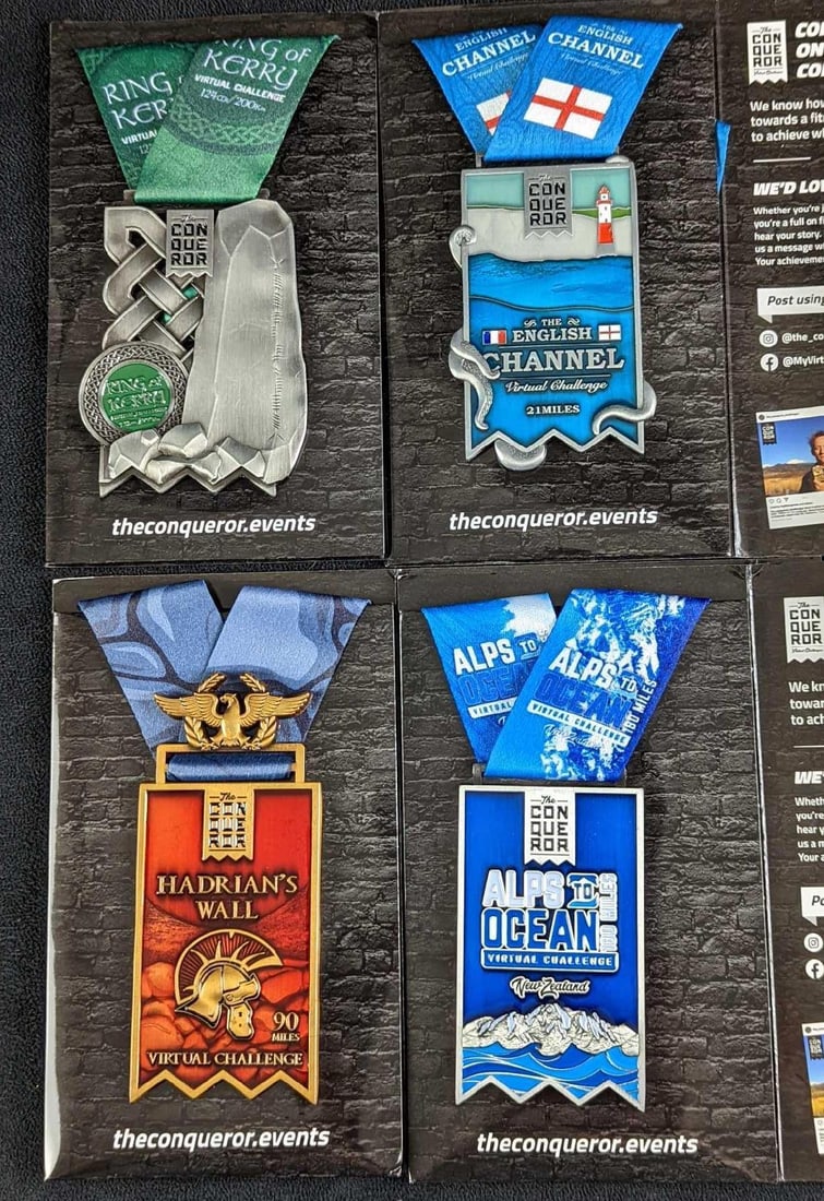 JB 4 Metal Conqueror Running Medals: This lot consists of metal medals that were acquired through the "Conqueror" virtual challenges. Each comes in its original packages which are approx 4 1/4" x 1/4" x 7" and