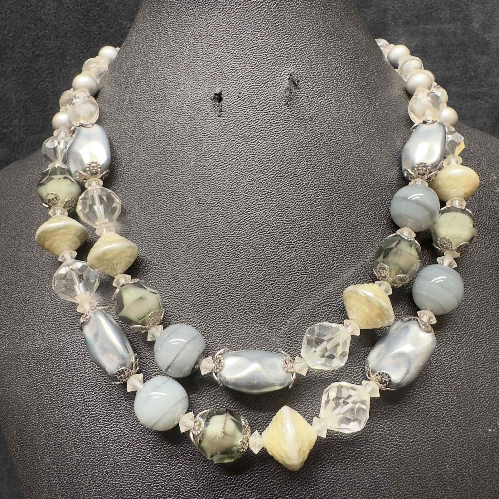 Vendome Clear Gray Silver Crystal Beaded Double Strand Necklace H92: Vendome Clear Gray Silver Crystal Beaded Double Strand Necklace H92. Necklace with clear, gray, and silver colored glass beads with beautiful designs. The necklace features a j hook clasp closure with