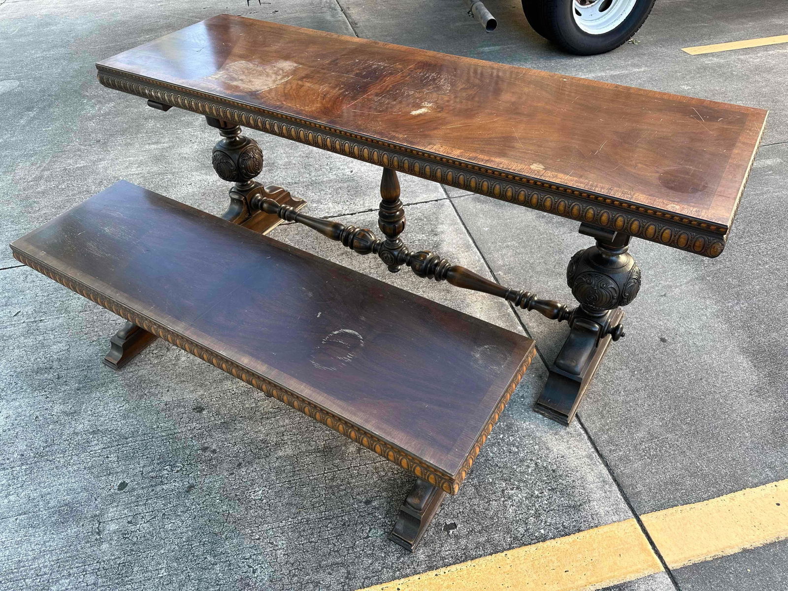 Vintage Wood Ornate Carved Trestle Table With Matching Bench: This lot contains a Vintage Wood Ornate Carved Trestle Table With Matching Bench. The approx measurements for both the table and bench are listed below. Overall the Table and Bench set is in good used