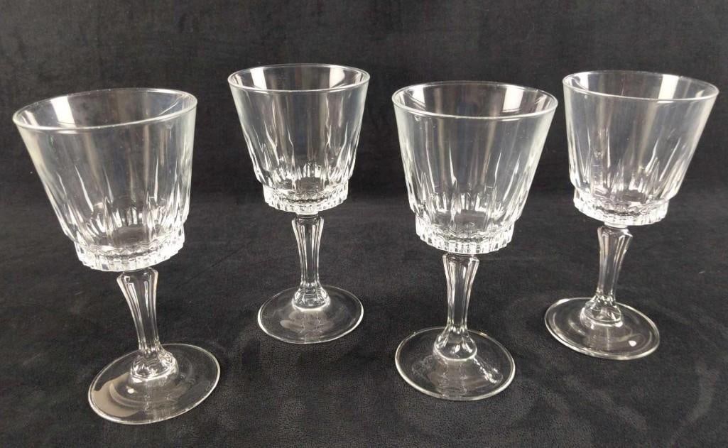 Four Stemmed Glass Water Wine Goblets: Four Stemmed Glass Water Wine Goblets. The maker and date of creation are unknown. Goblets are approx 3 1/2" x 3 1/2" x 7 1/8" and together they weigh 2.80lbs. The goblets are in good, used condition