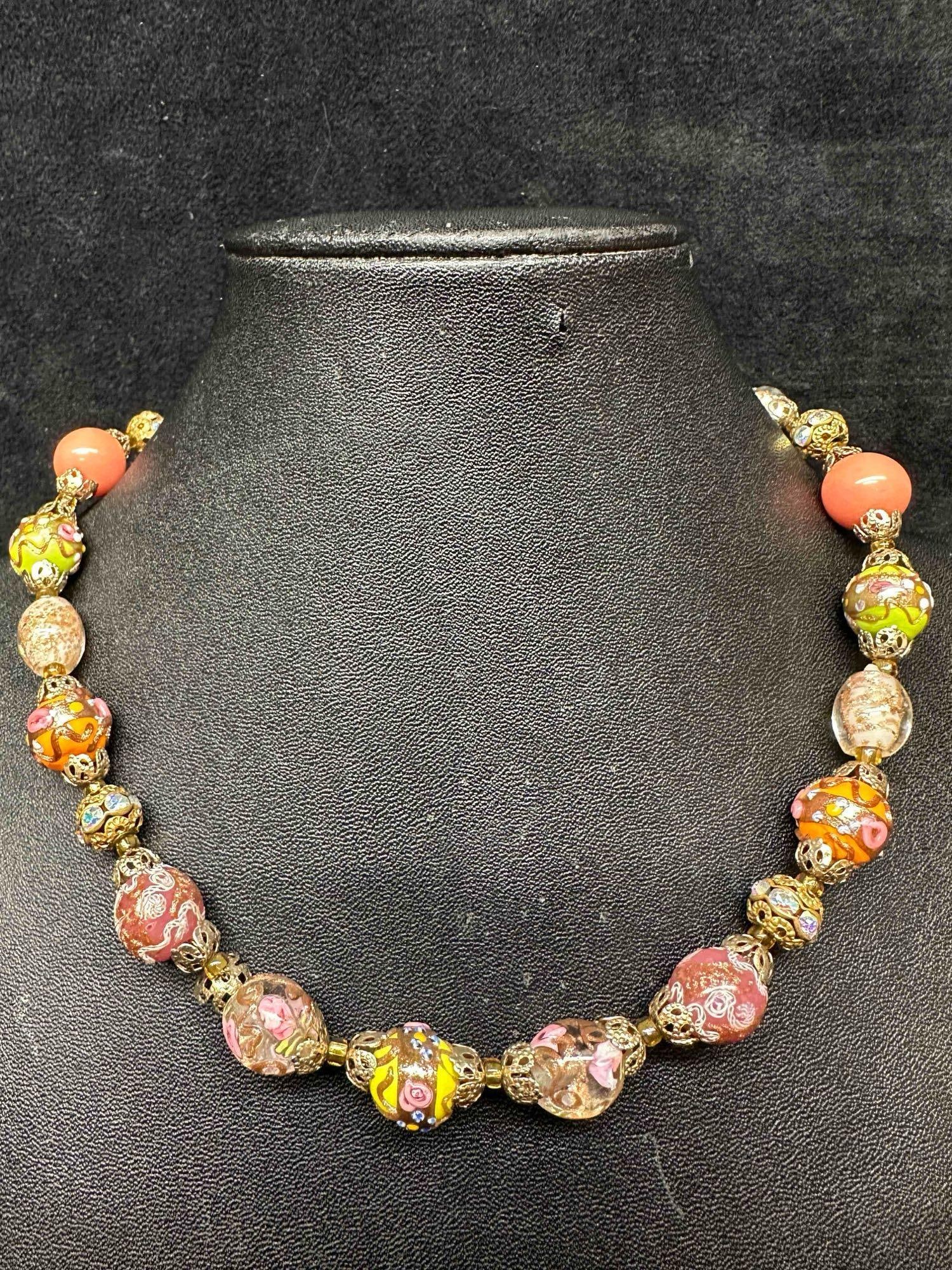Murano Venetian Lamp Work Art Glass Multi Colored Floral Copper Design Beaded Necklace F2: Murano Venetian Lamp Work Art Glass Multi Colored Floral Copper Design Beaded Necklace F2. Necklace with multi colored glass beads with a beautiful design on each. The necklace features floral and cop
