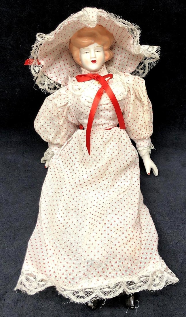 Vintage "The Gibson Girl" Porcelain Doll 16": Vintage "The Gibson Girl" Porcelain Doll wearing a White & Red Polka Dot Dress with Lace Trim, and Matching Hat. It is approx 16" x 4" x 2-1/2" and it weighs 0.5lbs. The Porcelain Doll is in a used, v