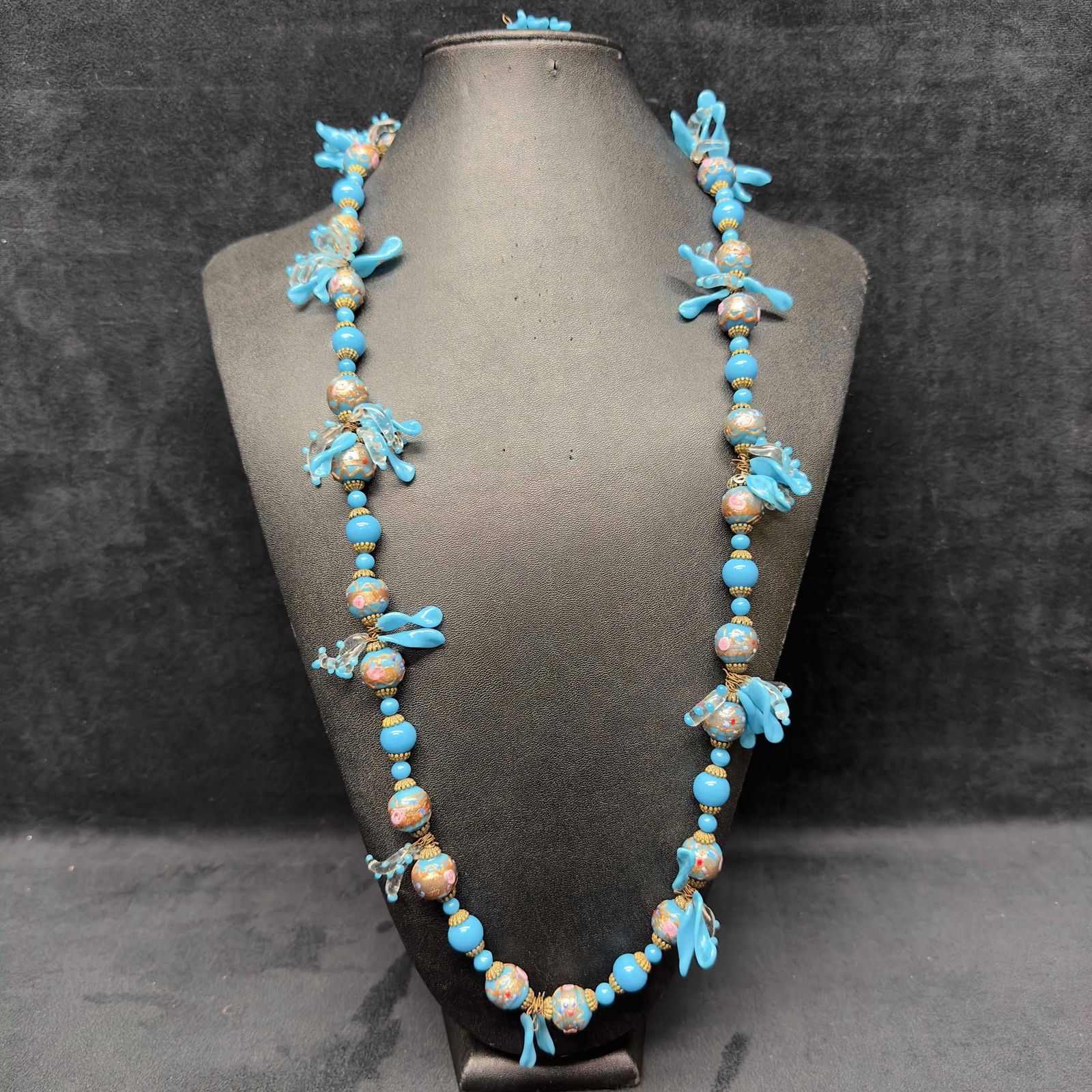 Venetian Murano Lamp Work Art Glass Clear and Sky Light Blue Leaf Bead Long Beaded Necklace D51: Venetian Murano Lamp Work Art Glass Clear and Blue Leaf Bead Long Beaded Necklace D51. Necklace with blue colored glass beads with beautiful designs on each. The necklace features clear and blue leaf