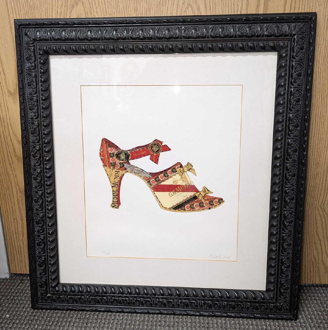 S&N Pamela Dale Champagne Shoe Rue De Babylone Print R69: S&N Pamela Dale Champagne Shoe Rue De Babylone Print R69. This framed print is approx 25 5/8" x 1 1/2" x 27 3/4" and it weighs 8.20lbs. The frame has some chips. This one is #11 out of #100. 