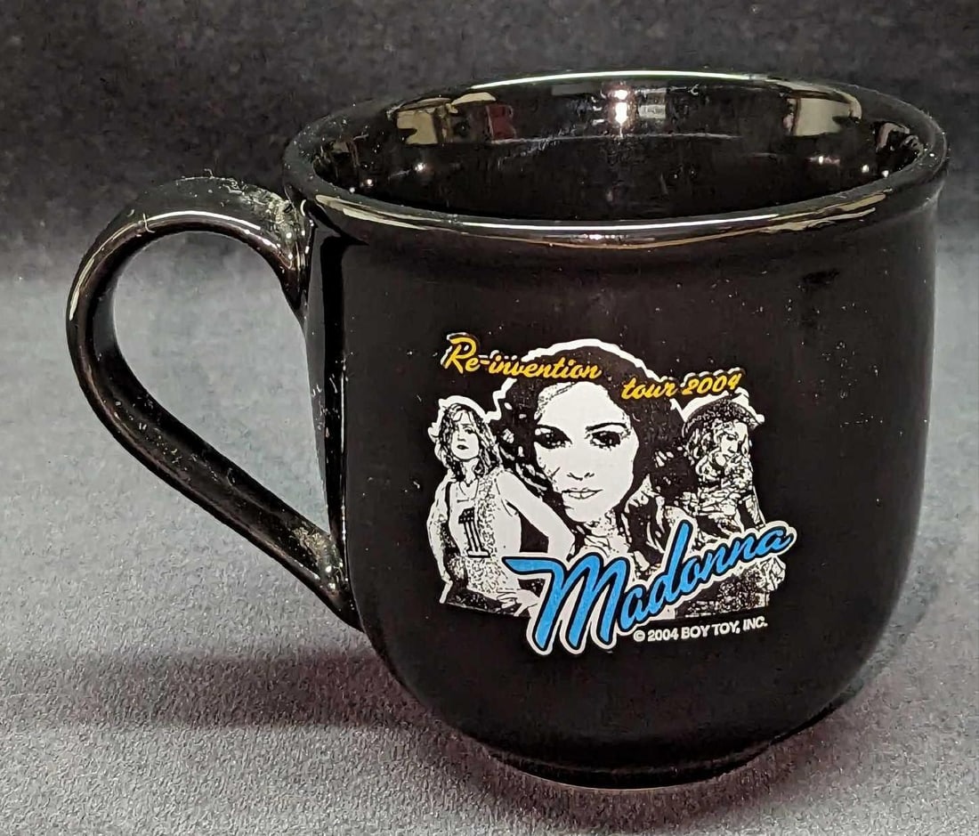 Madonna Reinvention Tour Ceramic Mug A: Madonna Reinvention Tour Ceramic Mug. By Linyi. The mug is approx 5 1/2" x 4" x 4" and it weighs 0.91lb. The mug has no chips or cracks.