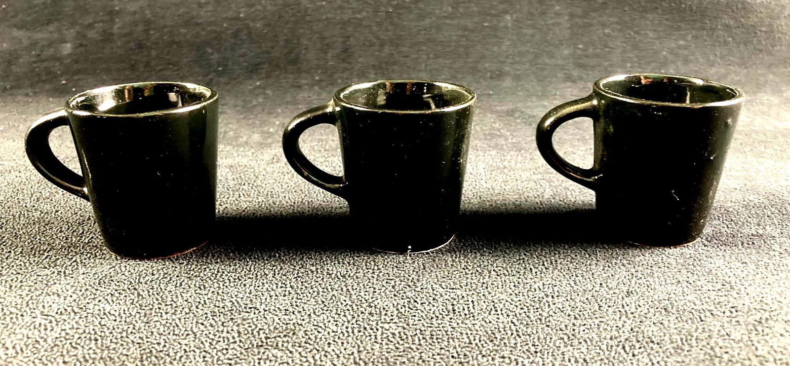 (3) Small Black Cups Made in Japan: This lot includes: (3) Black Cups Condition is used and see photographs for additional details. The cups are in good shape and have no evident chips or cracks. Only one of the cups has the