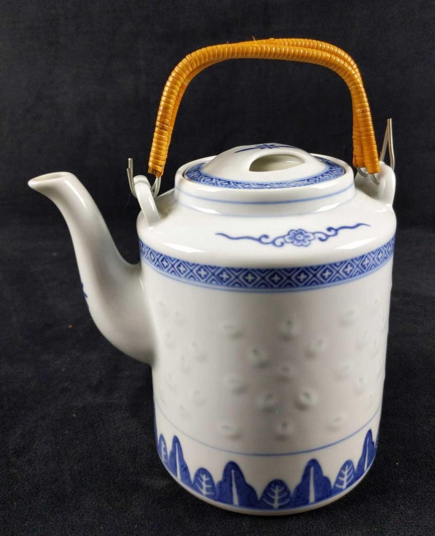 Vintage Tienshan Rice Windows Porcelain Teapot: Vintage Tienshan Rice Windows Porcelain Chinese Teapot. Part of Tienshan's "Rice Flower" series. Is approx 7" x 5" x 9" with handles up. Is in good, used condition with some dark markings on the back